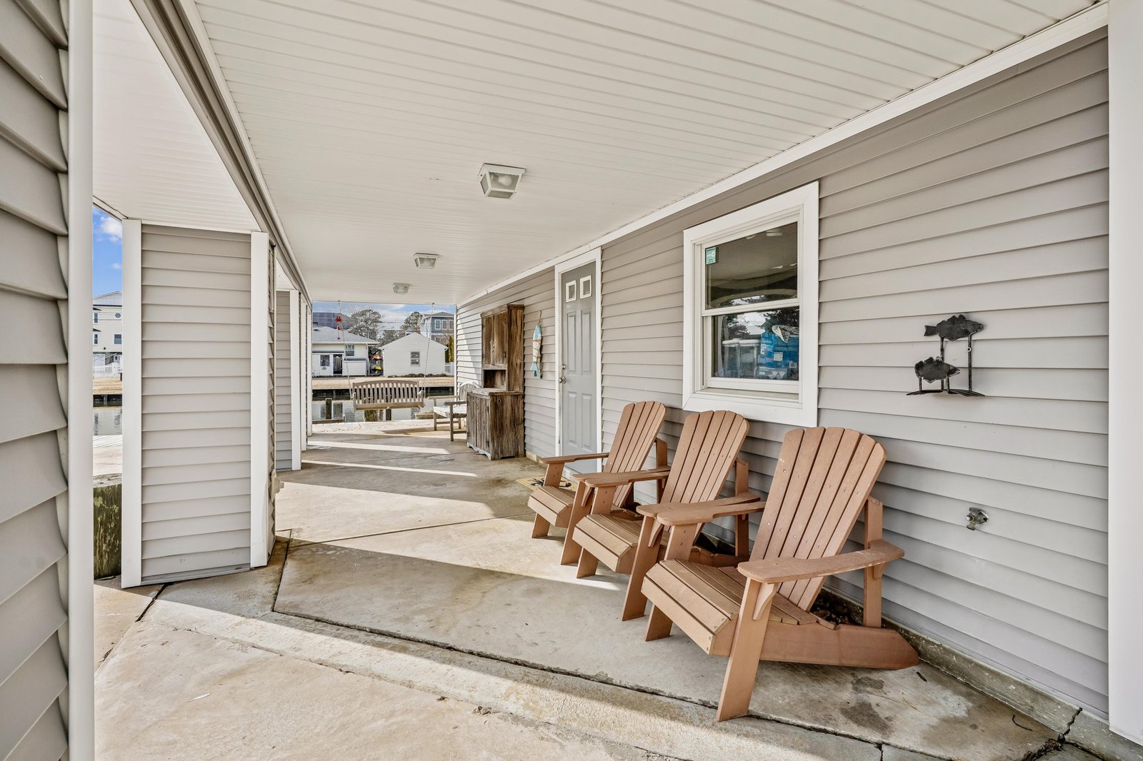 Settle into your private covered porch with classic Adirondack chairs—your perfect spot for morning coffee, evening relaxation, and soaking in coastal neighborhood views.