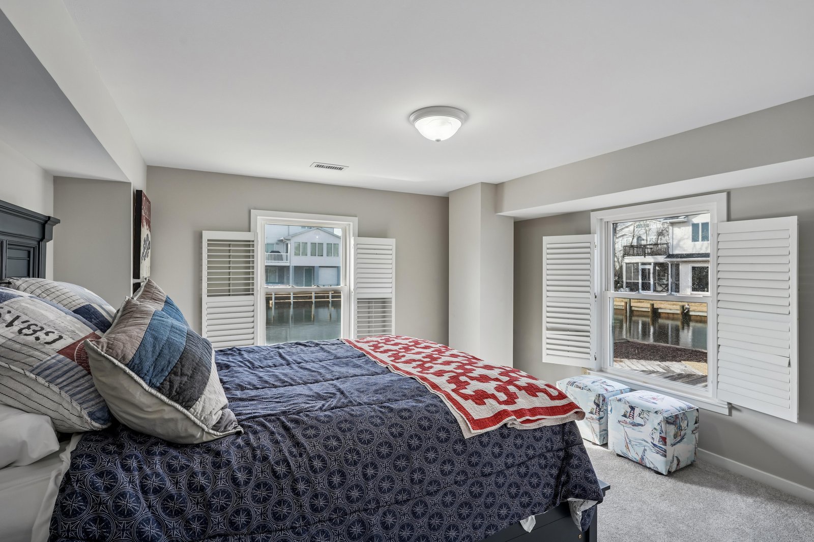 Wake up to marina views and coastal charm in this serene bedroom, where soft linens and tranquil tones invite restful mornings by the water.
