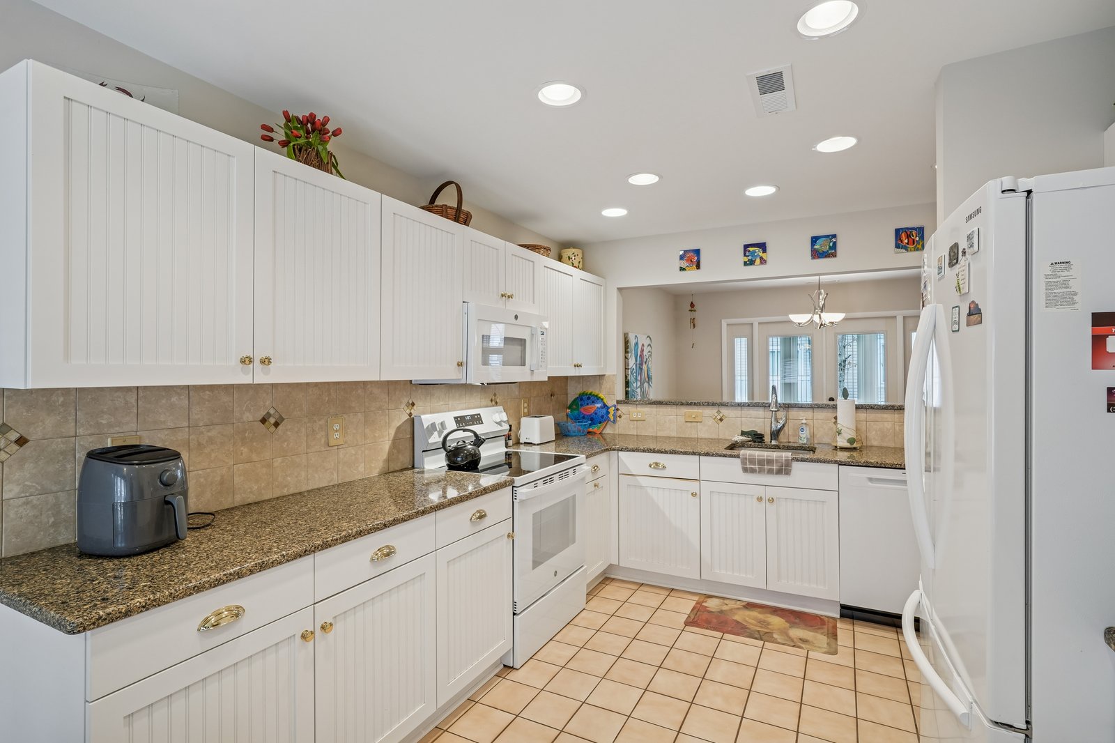 Your fully-equipped kitchen invites culinary adventures with granite counters, white cabinets, and modern appliances for memorable meal prep.