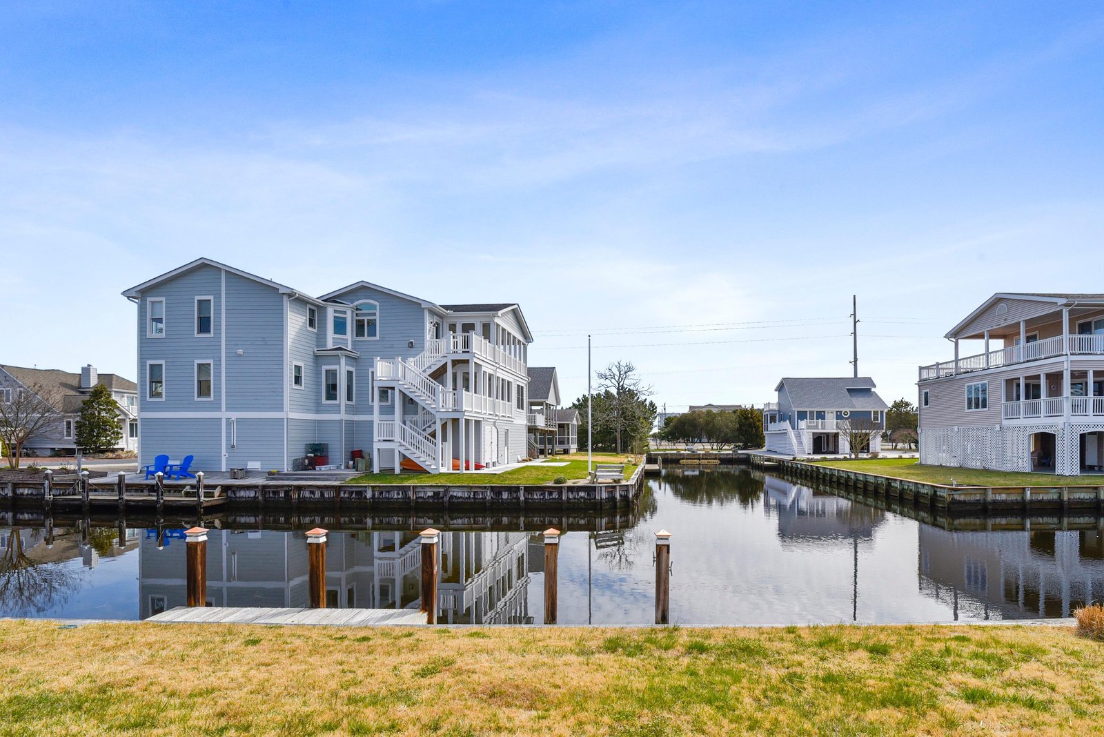 The property sits along a peaceful canal, with private docks and a waterfront yard perfect for launching kayaks, fishing, or simply soaking in the coastal serenity.