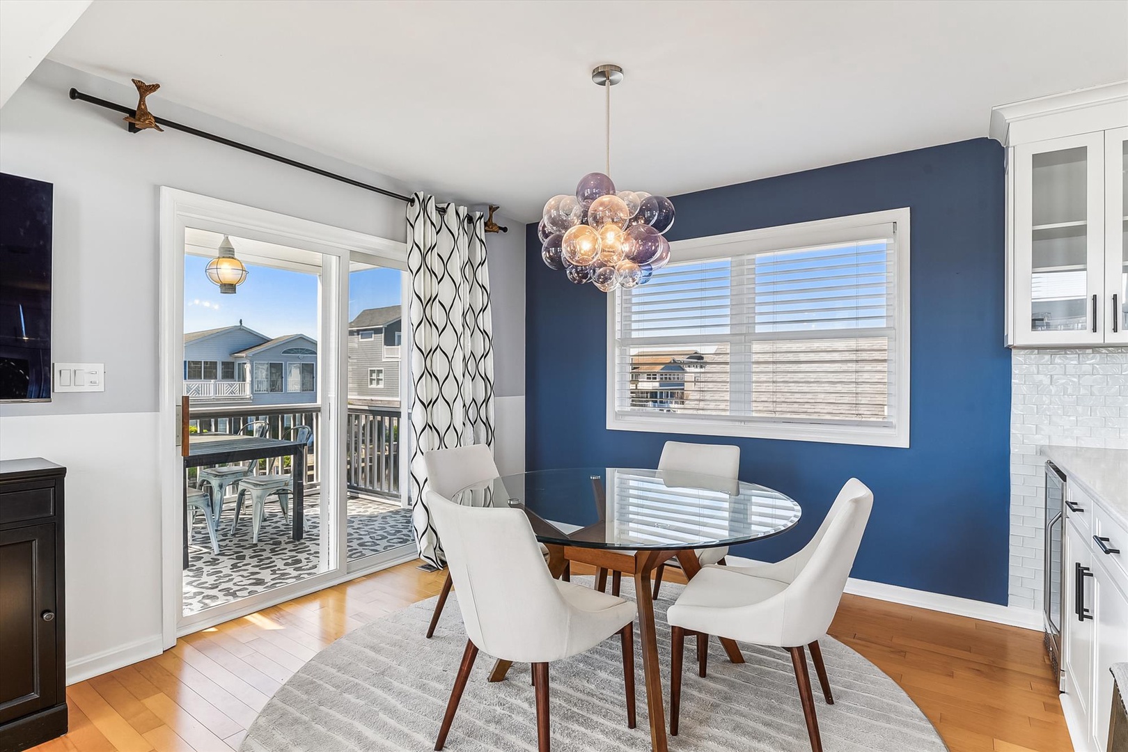 Gather around this inviting dining space with modern style and warm hardwood floors. Step outside to your private balcony for relaxing moments in the fresh air.