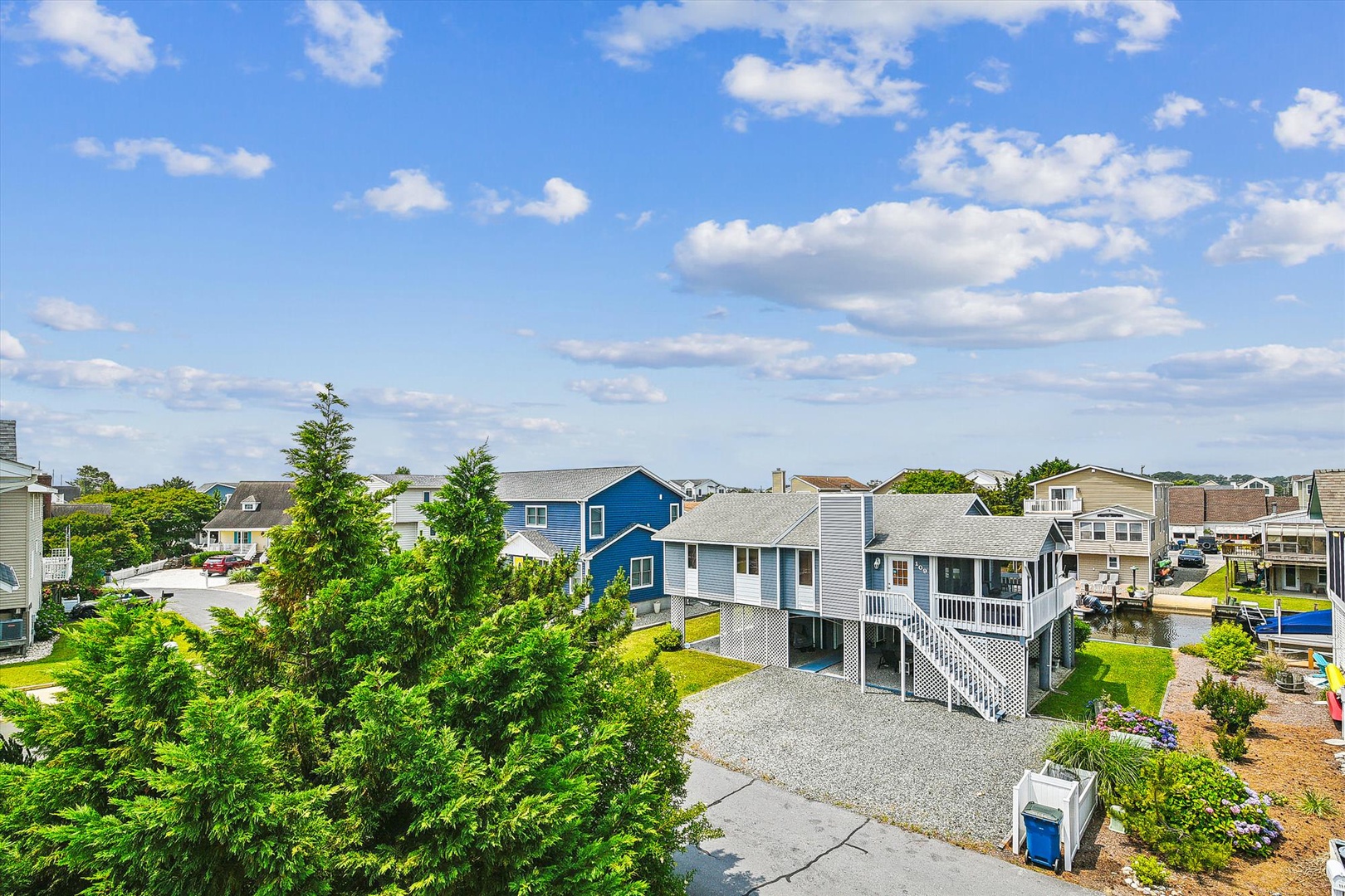 Elevated coastal property in a peaceful residential neighborhood with convenient parking and charming architecture. Perfect location near community amenities.
