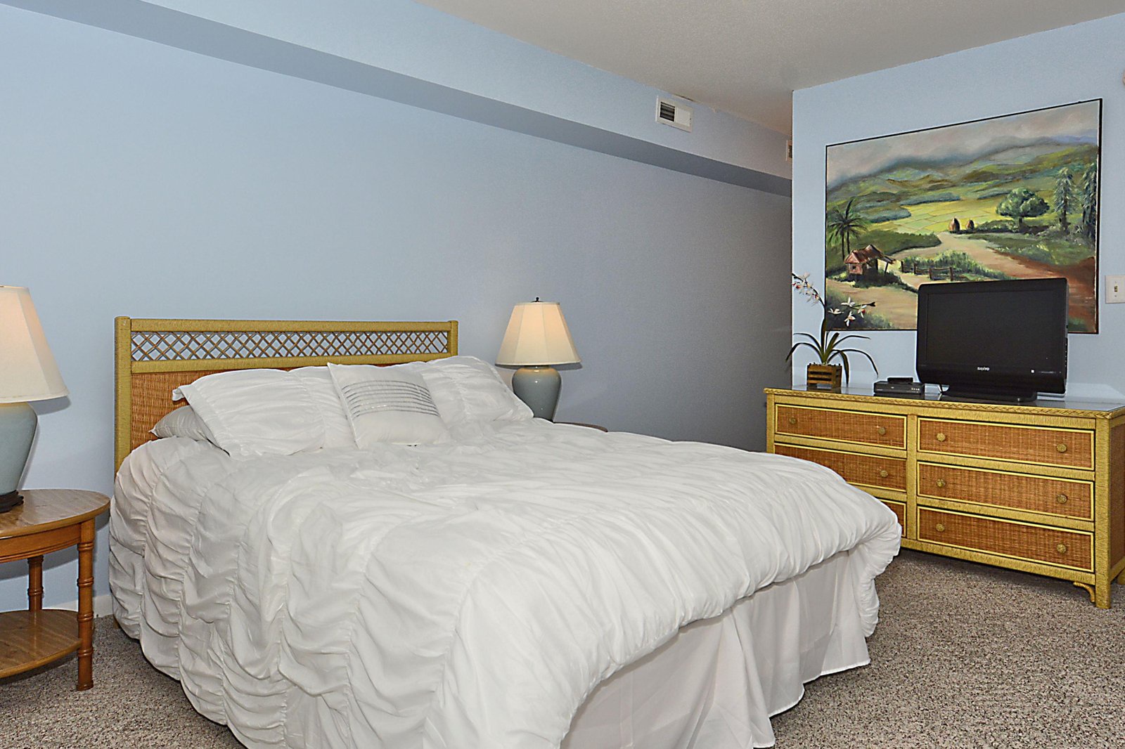 Slip into this restful bedroom where soft linens and coastal charm invite you to unwind after your island adventures.