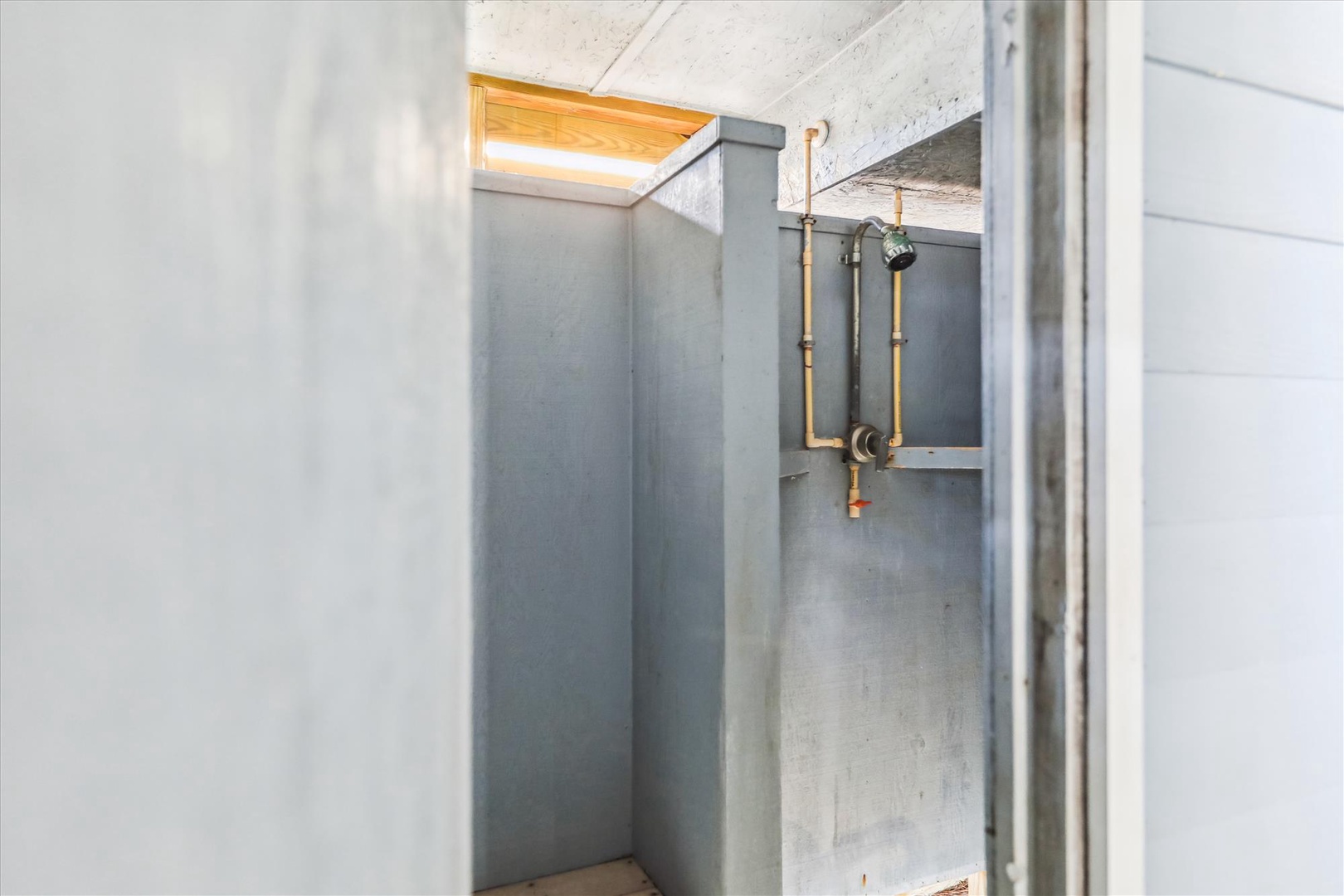 Rinse off in your private concrete and copper industrial-chic shower with natural skylight—minimalist design meets refreshing comfort.