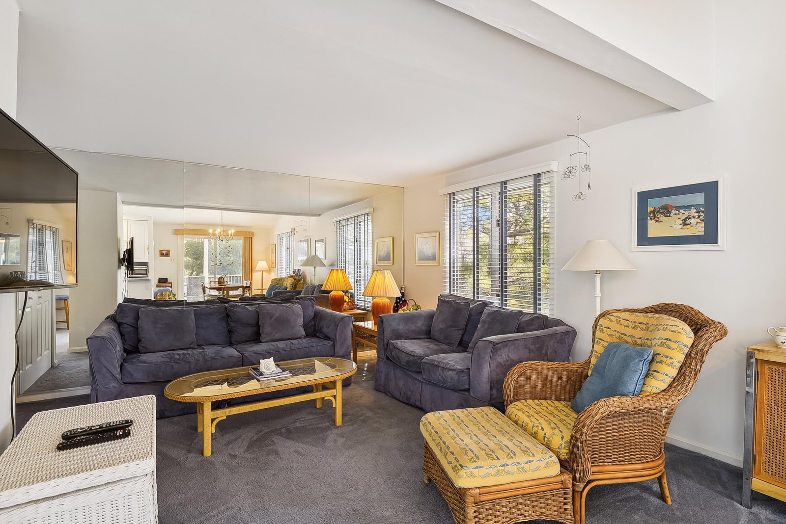 Stretch out in your bright, open living area with plush seating and plenty of natural light filtering through the blinds—perfect for gathering after a day of exploring.