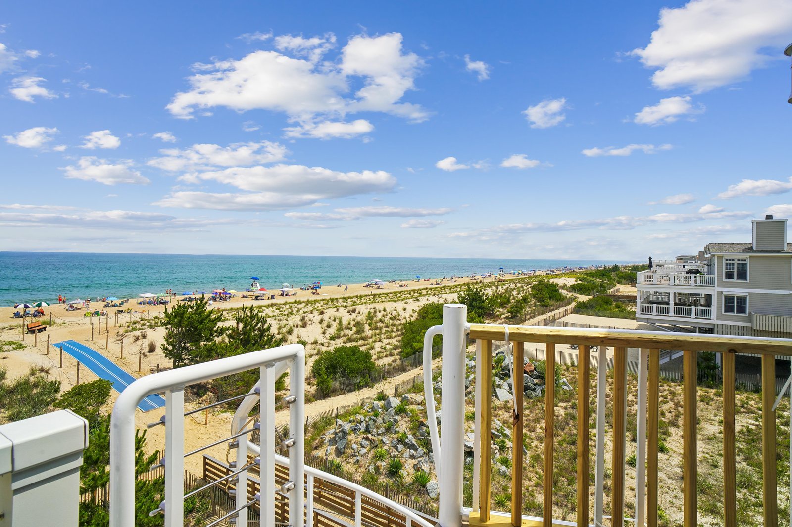 Step out onto your private balcony and drink in the sweeping ocean and beach views, where golden sands meet turquoise waters beneath a brilliant blue sky.