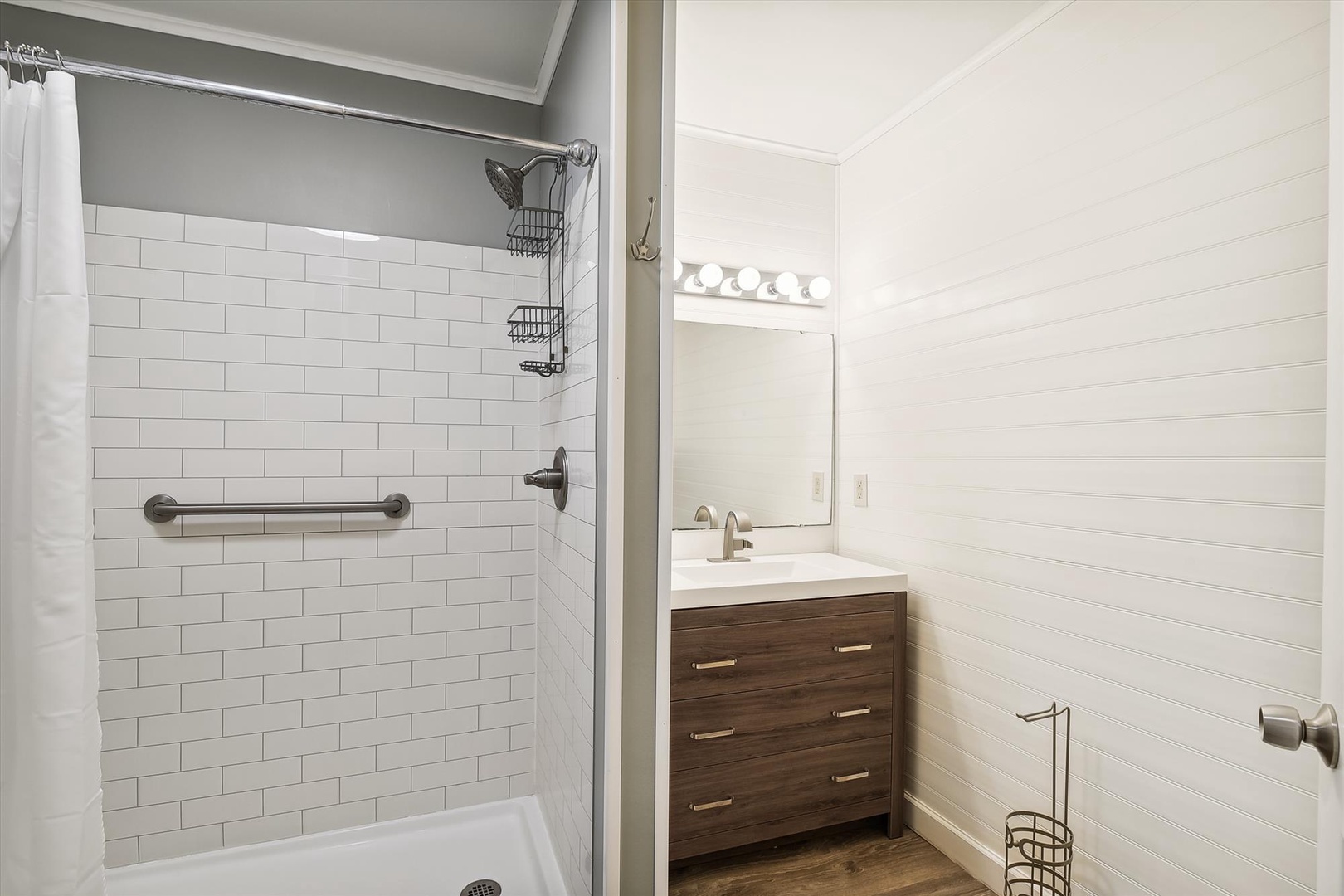 Your private bathroom features a bright, spotless design with a walk-in shower and generous vanity space—everything you need to refresh after a day of exploring.