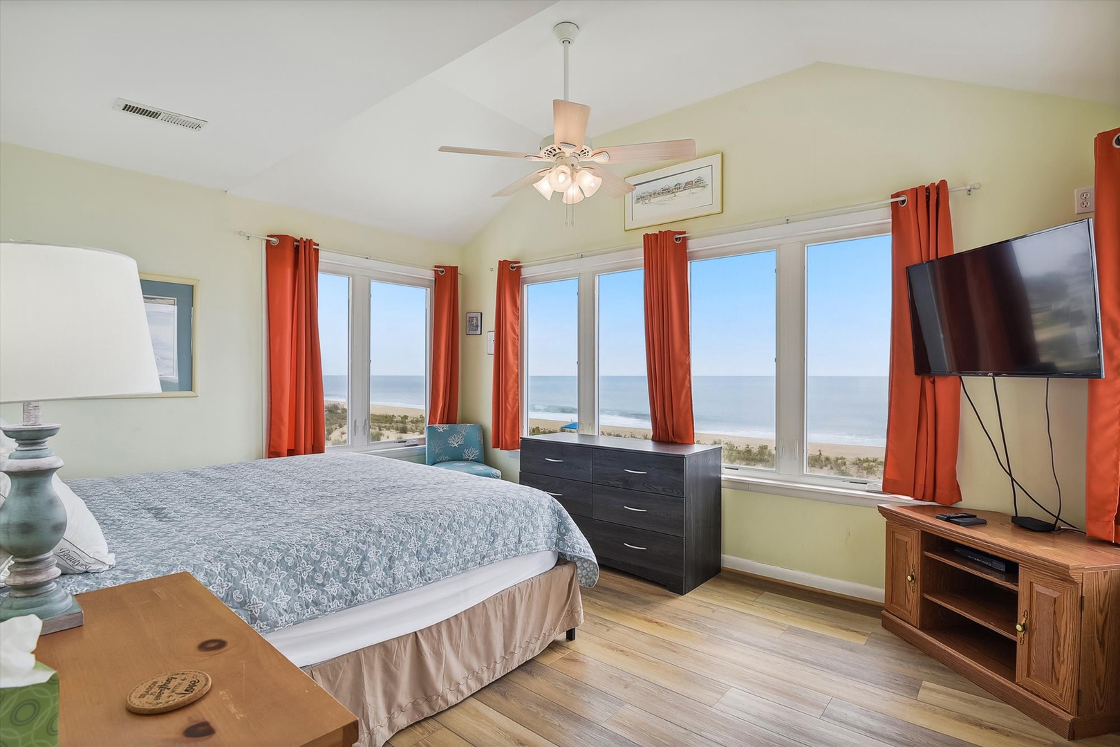 Wake up to breathtaking ocean views from your bedroom, where floor-to-ceiling windows frame the beach and rolling waves. Relax in comfort with a plush bed, ceiling fan, and flat-screen TV—your perfect coastal retreat.