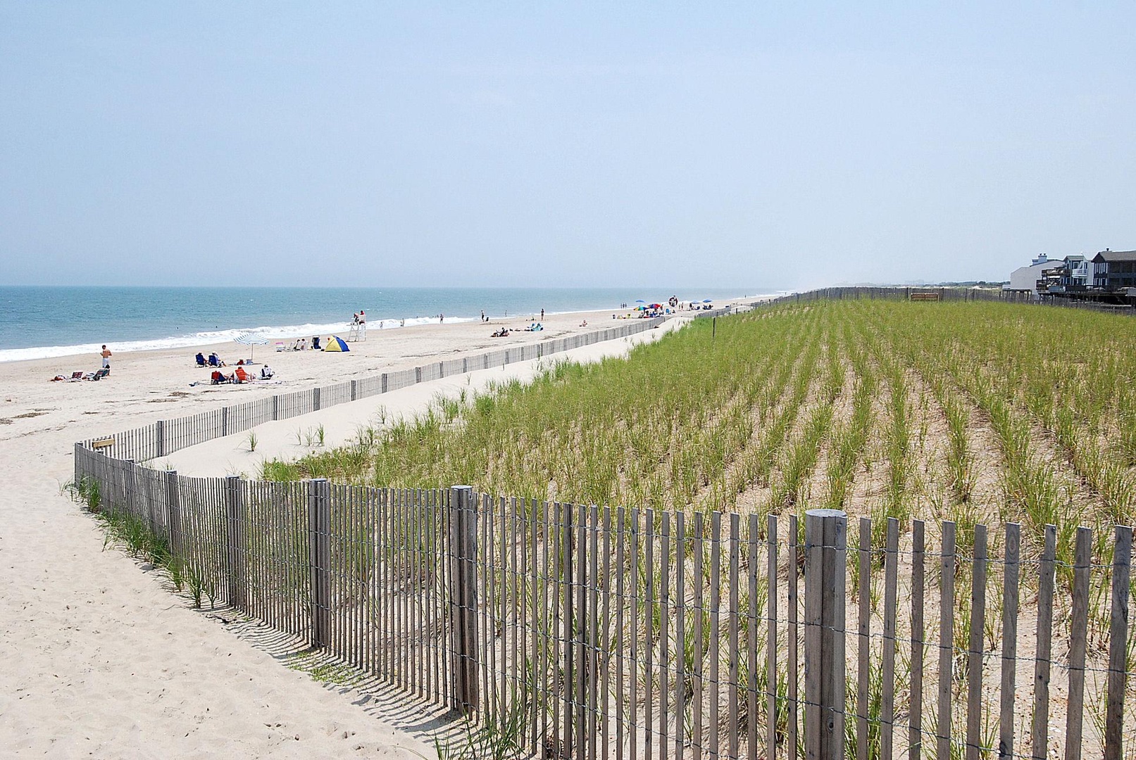 The property offers direct access to a pristine sandy beach, framed by coastal dunes and gentle ocean waves—ideal for leisurely beach days.