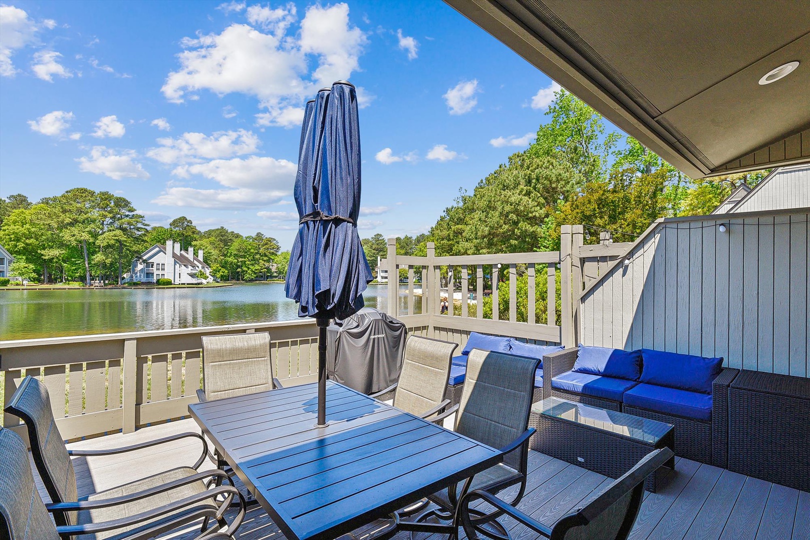 Picture yourself on this private waterfront deck, savoring morning coffee as sunlight dances across the peaceful lake, or unwinding with friends on plush seating under open skies.