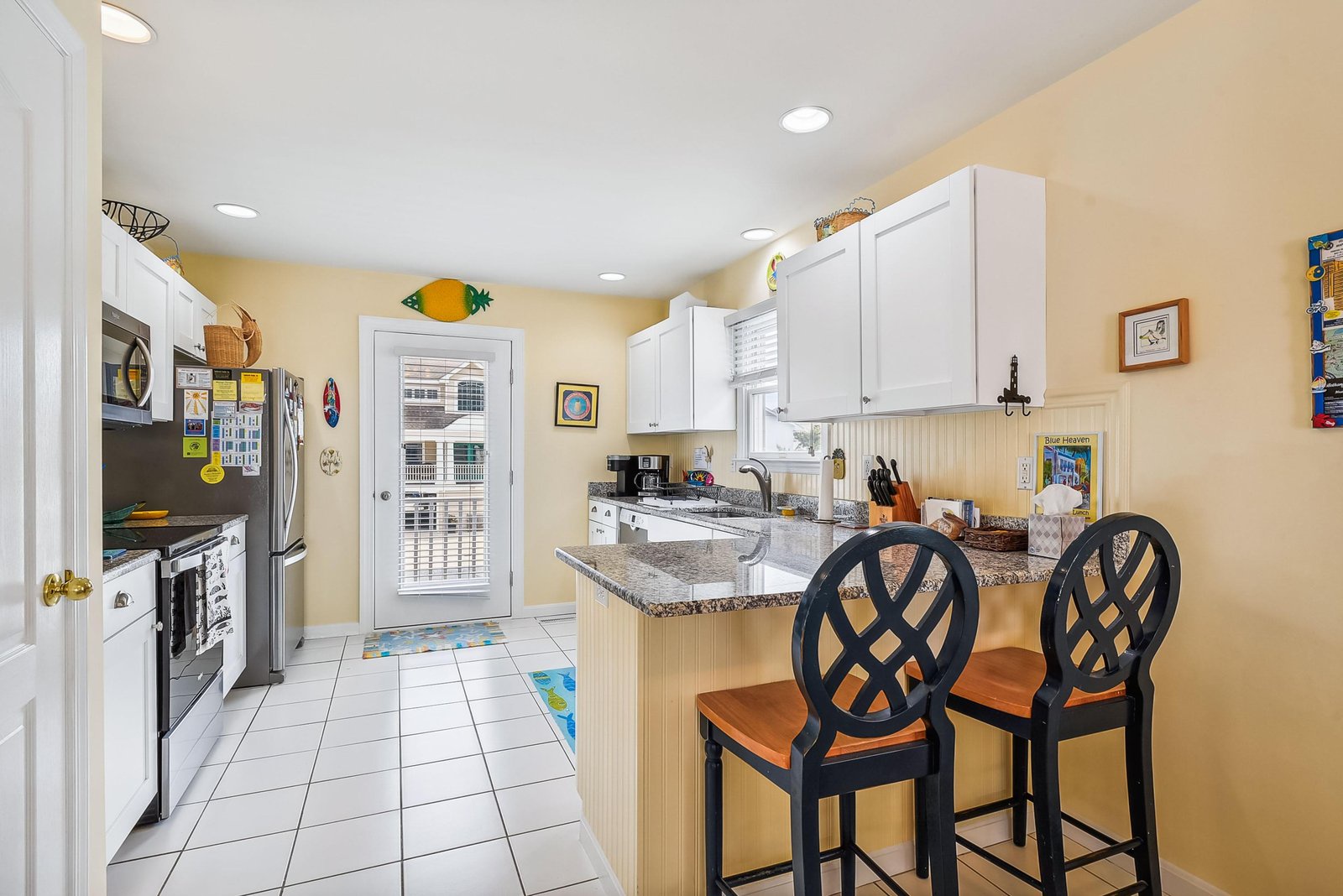 Your fully equipped kitchen awaits with bright, cheerful tones and everything you need to prepare meals during your stay. Settle in at the breakfast bar with your morning coffee and plan your day's adventures.