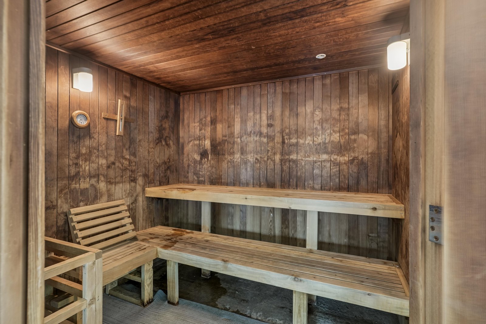 A peaceful sauna featuring warm wooden benches and walls, designed for your ultimate relaxation and rejuvenation after a day of adventure.