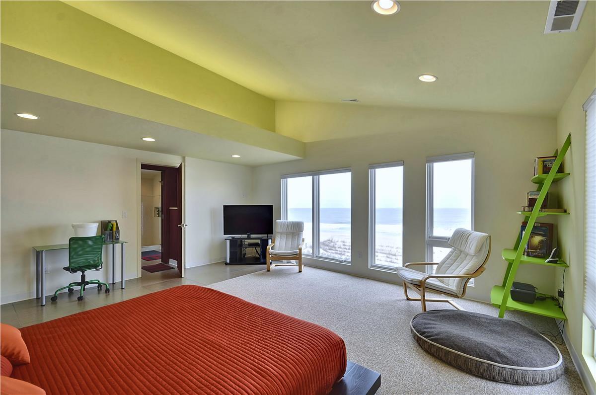 Wake up to sweeping water views from your spacious bedroom, where floor-to-ceiling windows frame the coastline and fill the room with natural light.