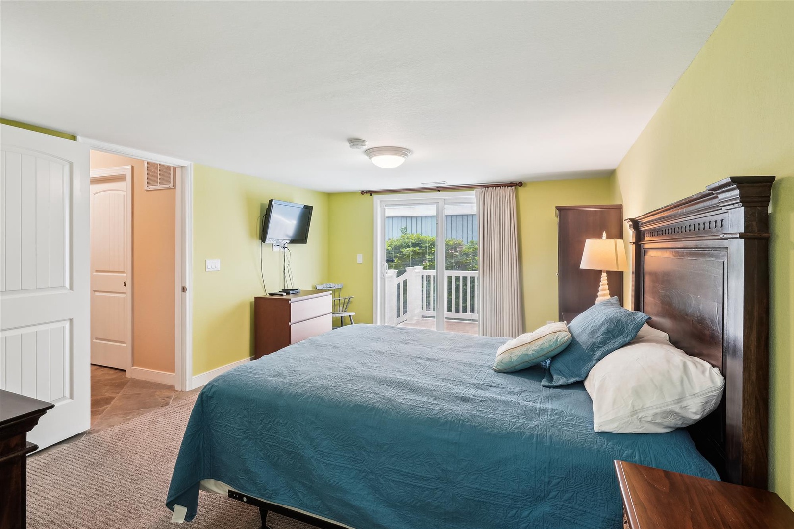 Wake up refreshed in this cheerful bedroom with bright walls, a plush bed, and private balcony access. Your peaceful retreat awaits with natural light and all the comforts of home.