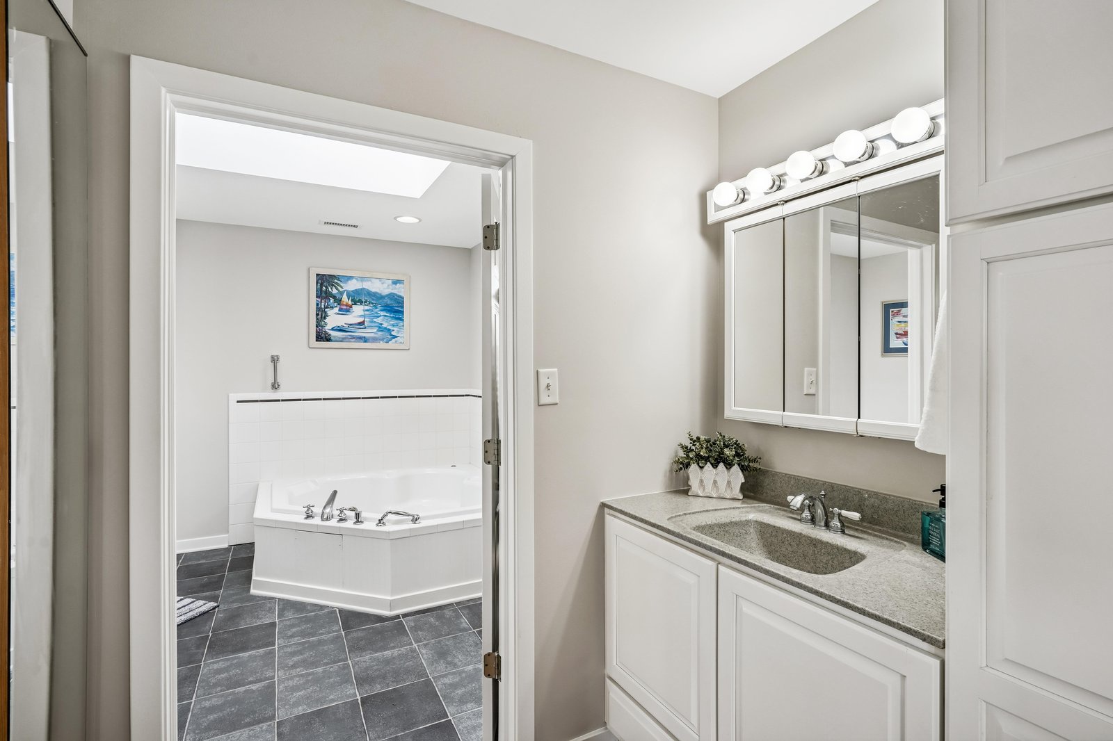 Your private bathroom features a spacious vanity with ample storage and a luxurious soaking tub just steps away, perfect for unwinding after a day of adventure.