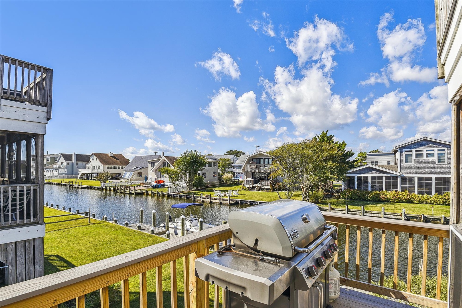 A stainless steel gas grill awaits your culinary creations on this spacious deck overlooking tranquil waterfront views, perfect for al fresco dining and entertaining.