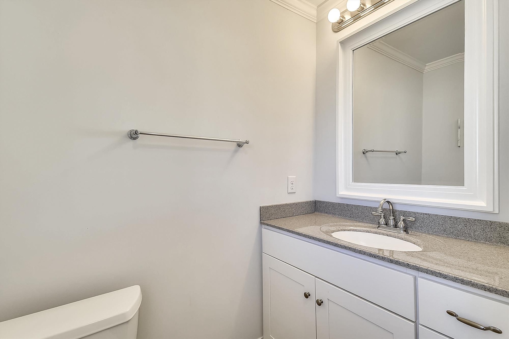 Freshen up in your private bathroom, featuring a spacious vanity with granite countertops, bright lighting, and plenty of storage for all your essentials.