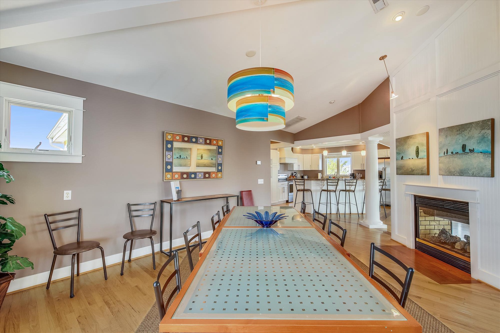 Gather around this stylish dining table where memories are made. The open-concept design flows seamlessly into the kitchen, while the cozy fireplace adds warmth to your evenings together.