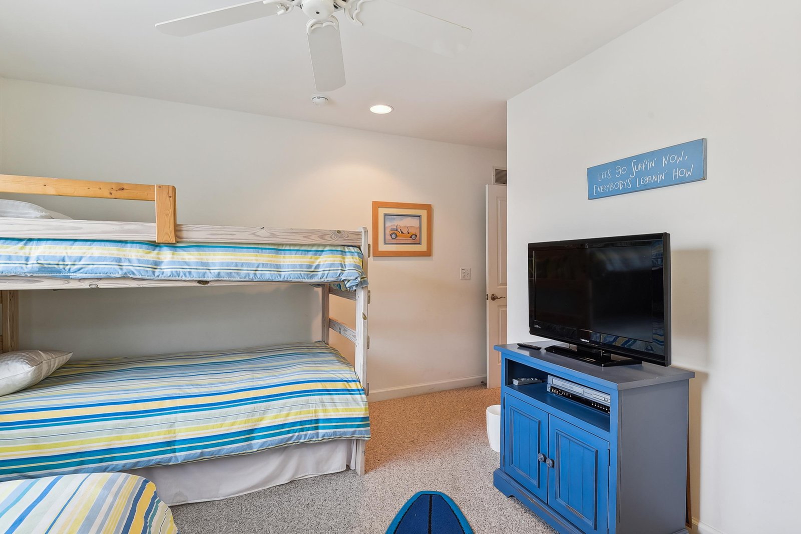Bunk room features cozy twin-over-twin beds with cheerful striped bedding and your own TV for movie nights and downtime.