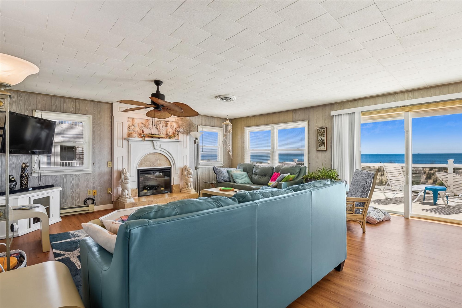 Sink into plush seating and watch the waves through floor-to-ceiling windows. Your beachfront living room features a cozy fireplace, spacious sofas, and sweeping ocean panoramas that make every moment unforgettable.
