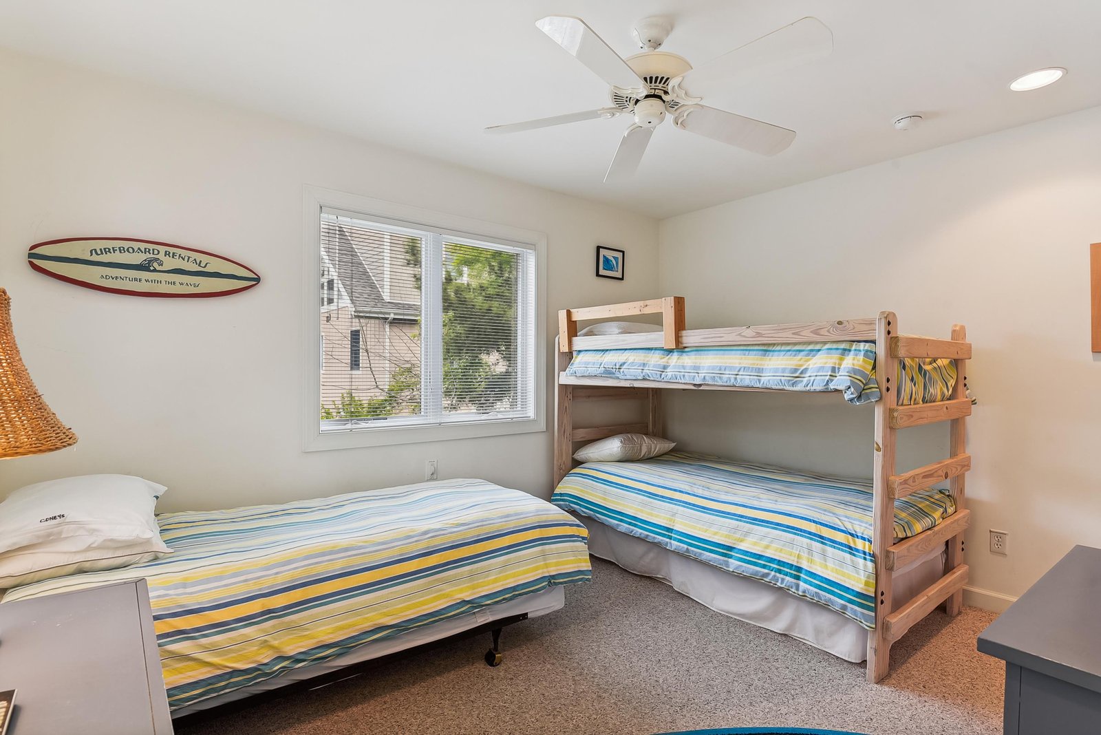 Cheerful room perfect for families and groups, featuring flexible sleeping with a cozy bunk bed and additional bed. Surf-inspired décor and bright natural light create a fun, beachy atmosphere.