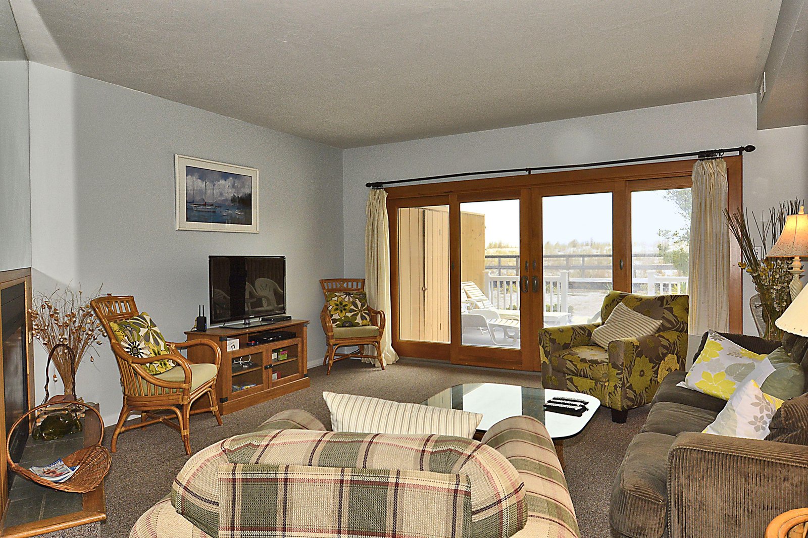 Settle into your cozy living room with soft seating, warm natural light streaming through French doors, and a TV for evening relaxation after your day's adventures.