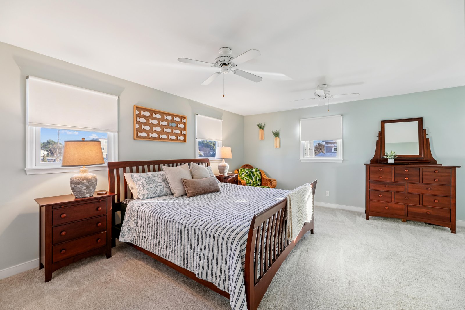Your spacious bedroom sanctuary features coastal-inspired décor, plush bedding, and warm wood furnishings—perfect for peaceful mornings and restful nights.