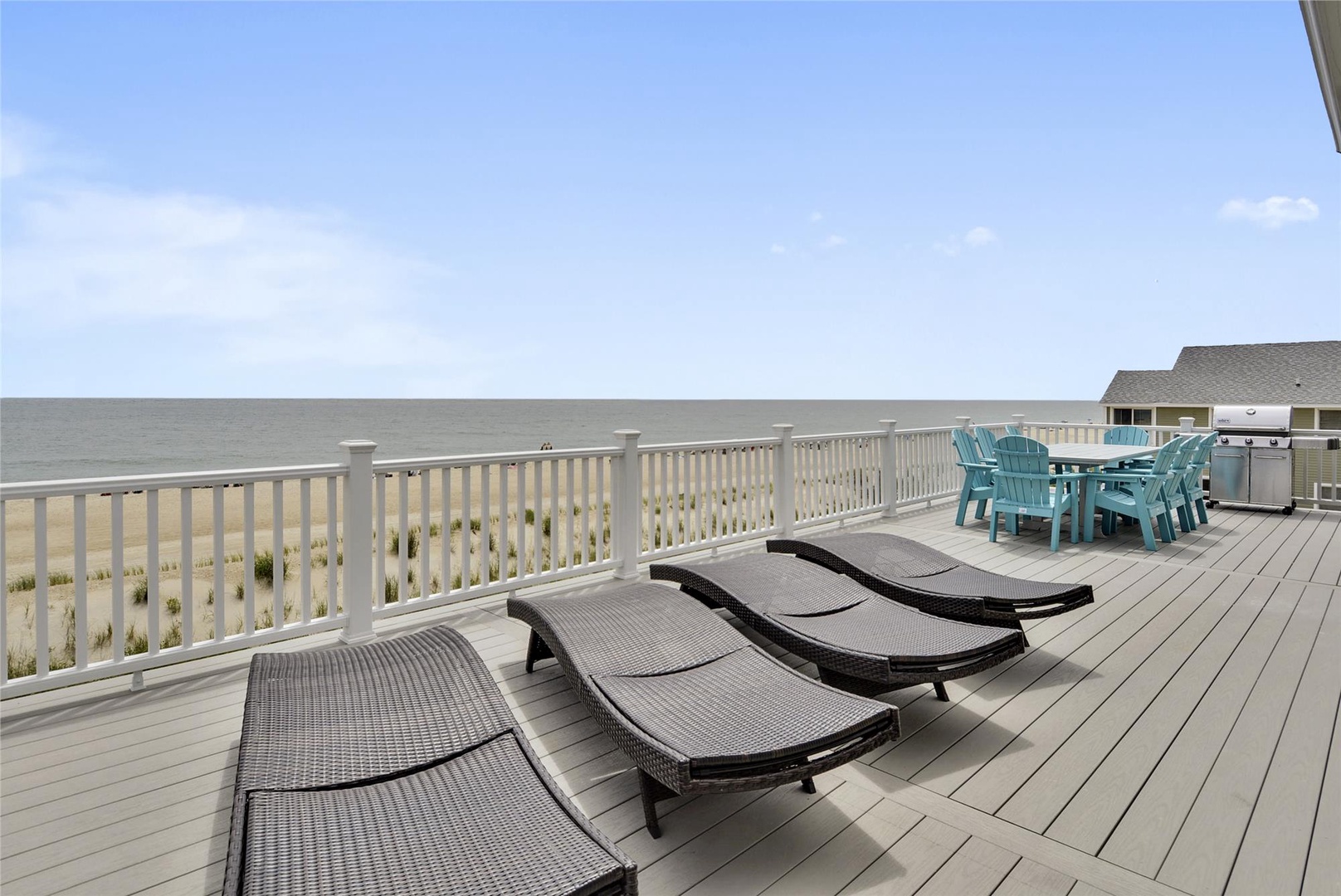 The spacious beachfront deck overlooks the sea and includes lounge chairs for sunbathing, outdoor dining for meals with a view, and a grill for preparing fresh catches. Perfect for relaxing by the water.