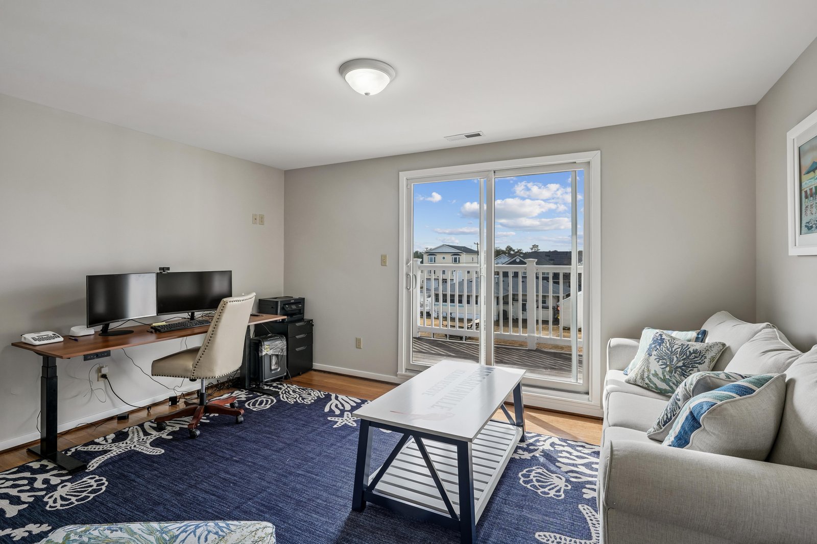Settle into your bright, welcoming living space with comfortable seating, workspace, and sunny balcony access overlooking the peaceful neighborhood—perfect for relaxing days.