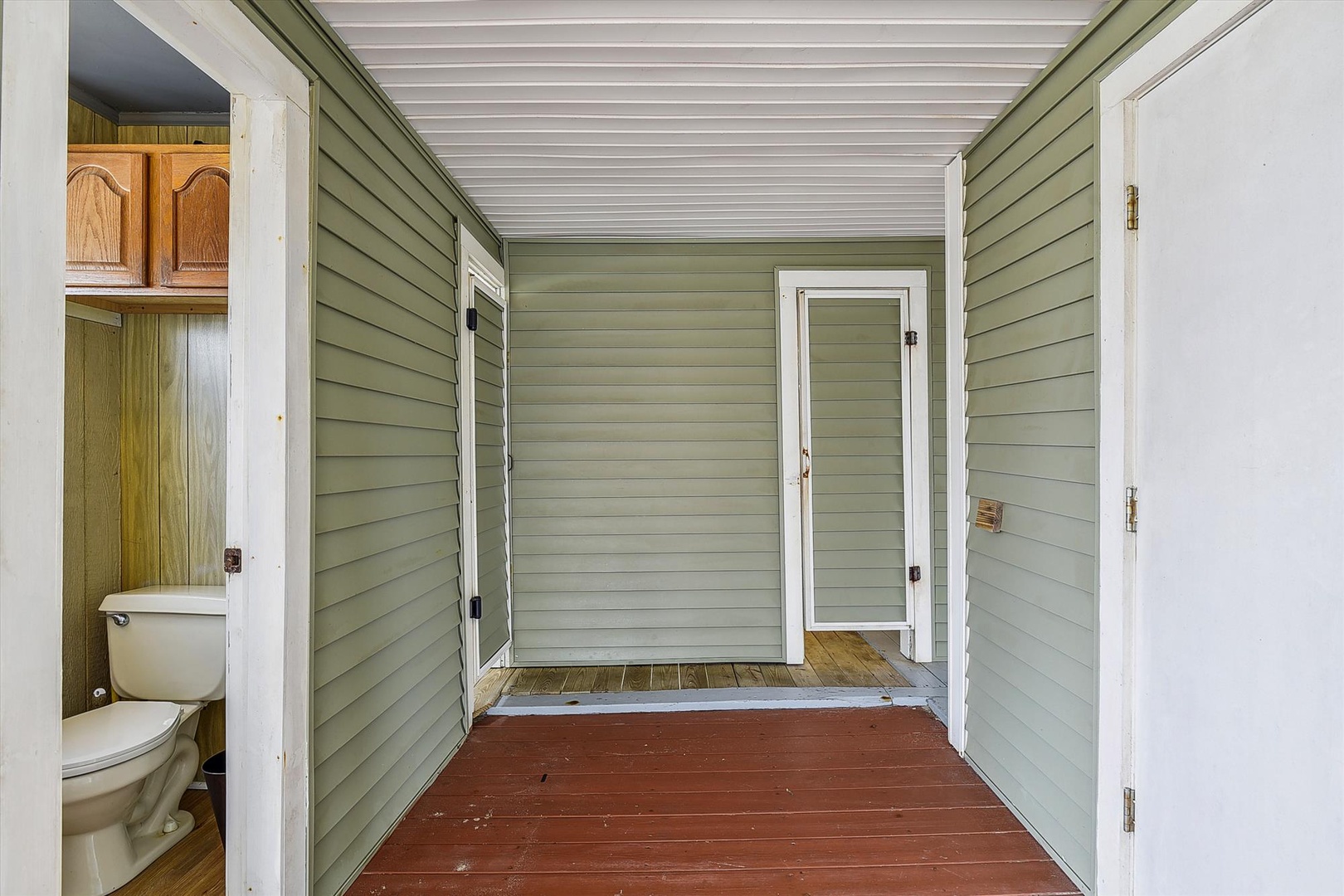 Your private covered porch offers a sheltered outdoor retreat, complete with convenient access to a half-bath for your comfort during outdoor relaxation.