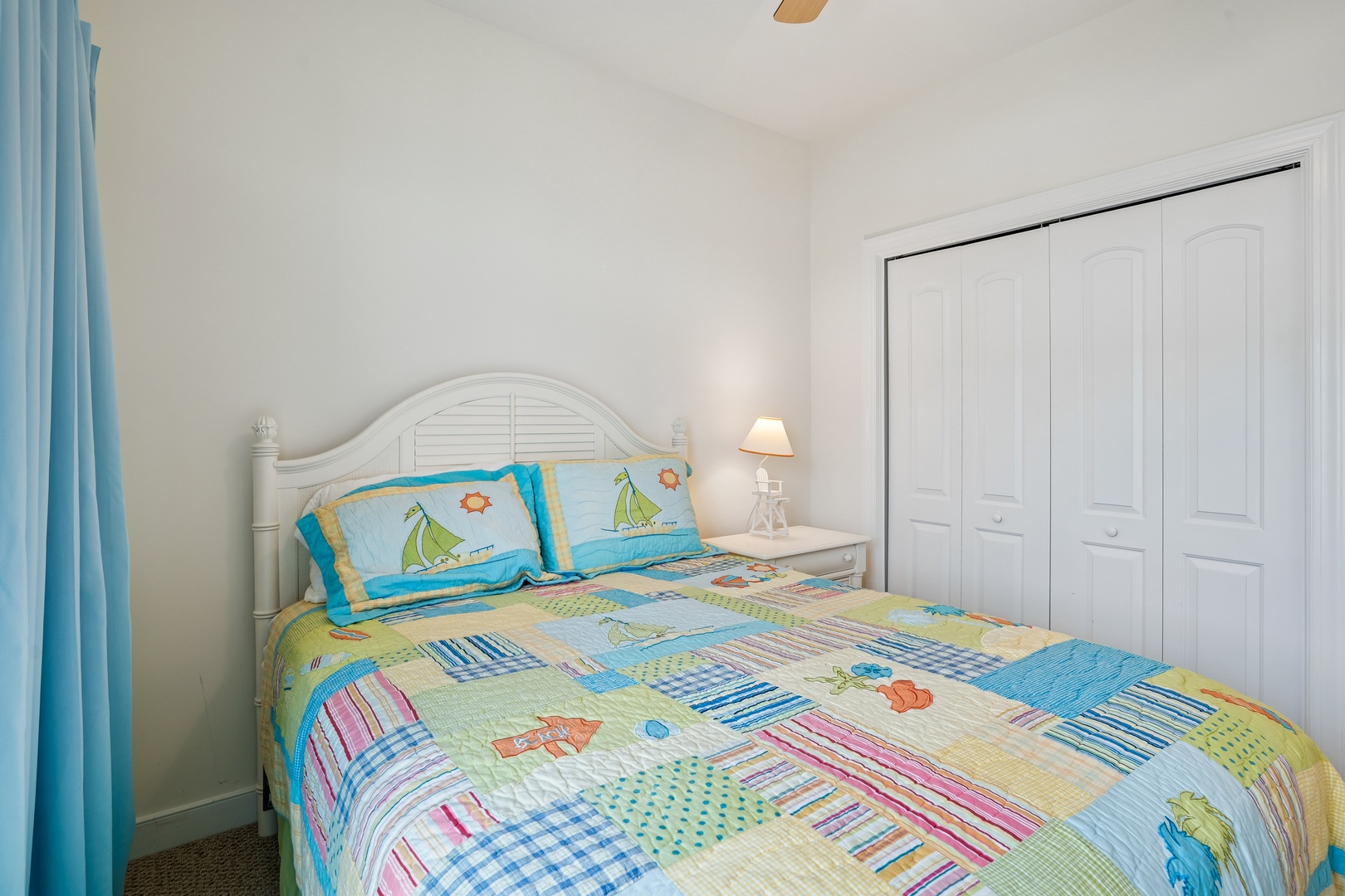 Drift off peacefully in your cozy bedroom featuring cheerful coastal bedding and plenty of storage space for your belongings.