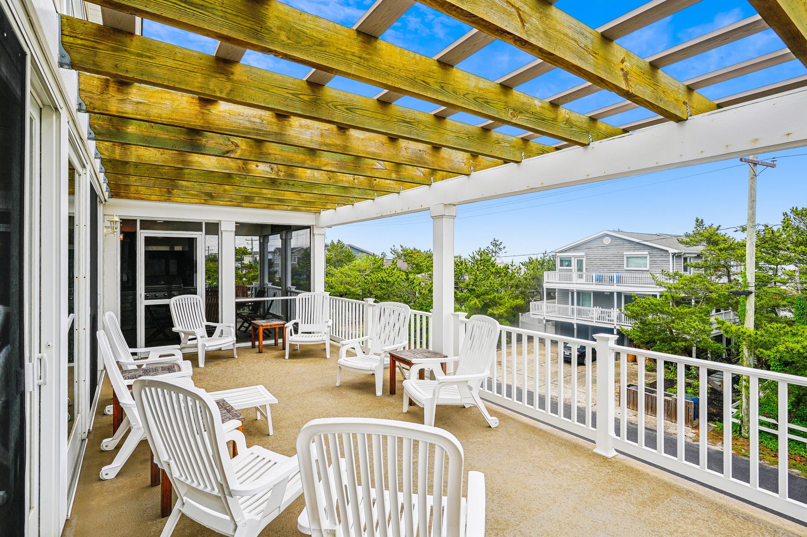 Settle into your lounge chair under the pergola and let the coastal breeze sweep over you. This spacious deck is your outdoor sanctuary, perfect for morning coffee or sunset cocktails.