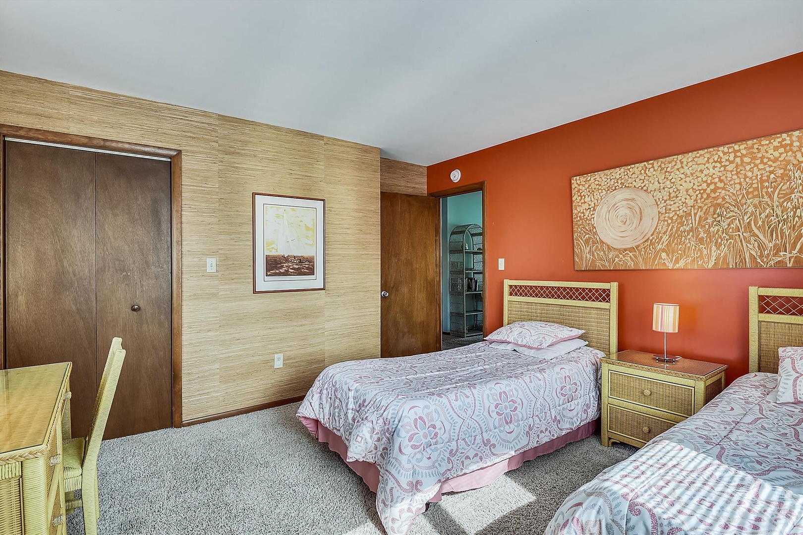 Cozy bedroom with two comfortable beds, vibrant decor, and a peaceful atmosphere ready to welcome you home after a day of adventure.