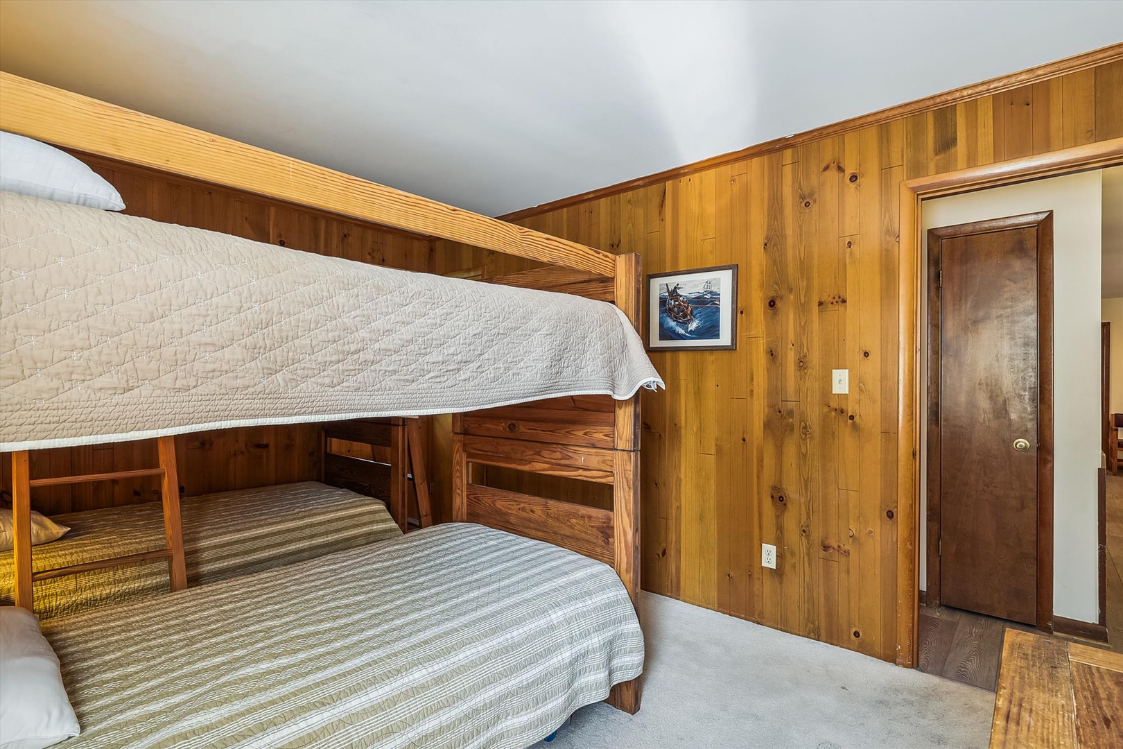 Your cozy cabin retreat with warm wood-paneled walls and a bunk bed setup perfect for family adventures in the mountains. Fresh linens await your arrival.