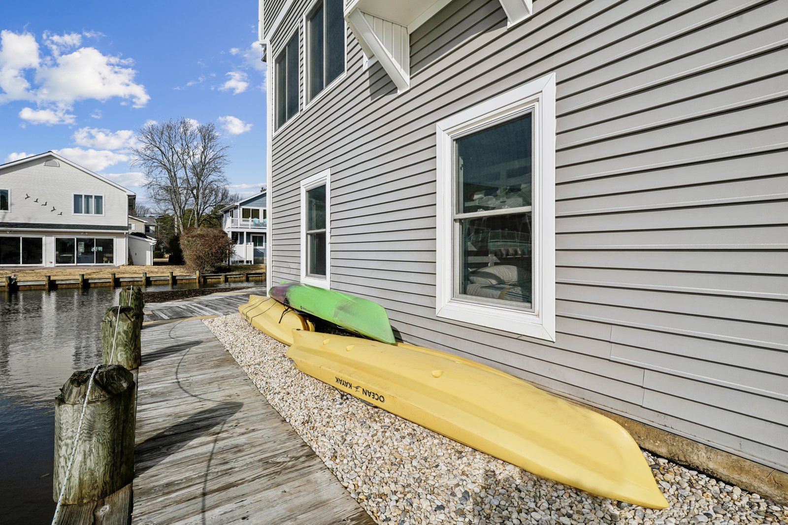 Waterfront property with kayaks ready for your next paddling adventure on calm waters.