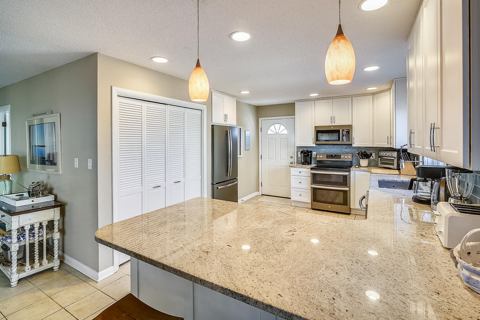 Step into your fully-equipped kitchen, where sparkling granite counters and modern appliances make meal prep a breeze, whether you're brewing morning coffee or whipping up a vacation feast.