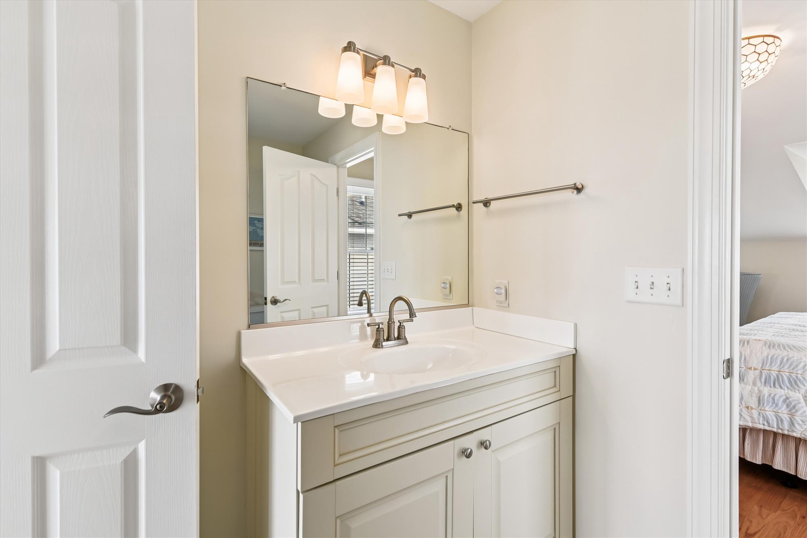 Freshen up in this crisp, well-lit bathroom with ample counter space and thoughtful accessibility features—ready for your morning routine.