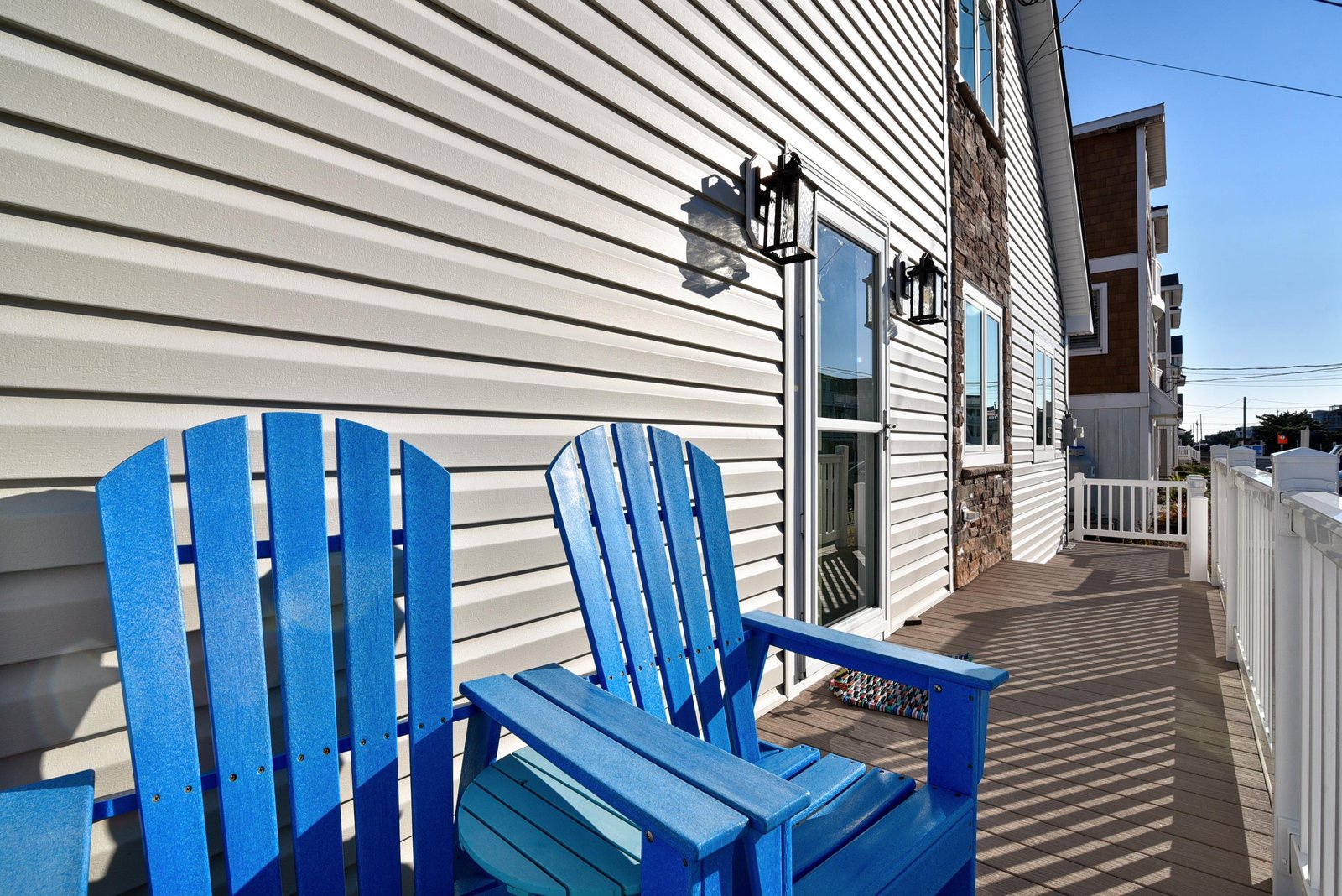 Settle into bright blue Adirondack chairs on your private deck—perfect for morning coffee or evening relaxation with the fresh sea breeze.