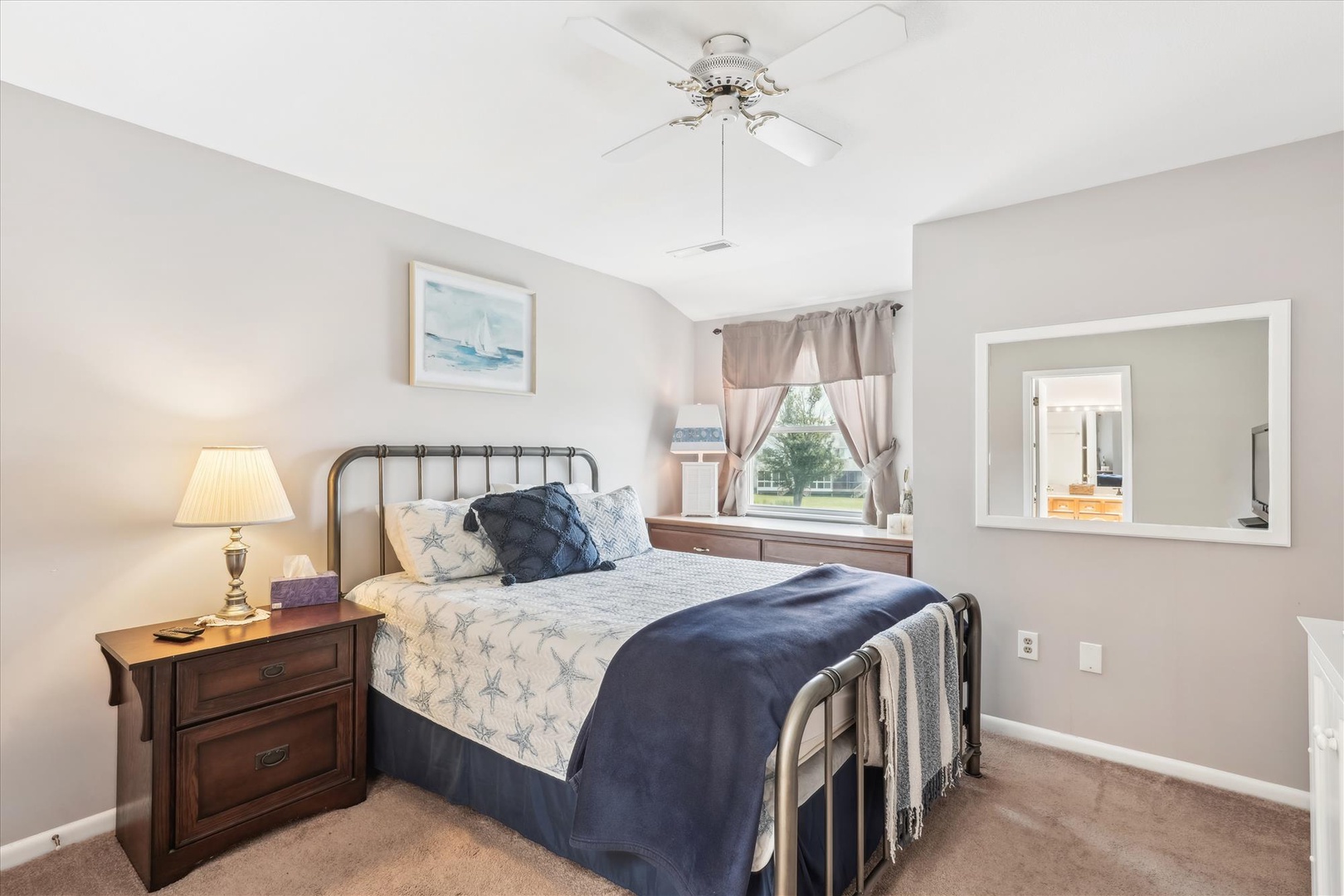 Sink into the plush bed and drift off under gentle ceiling fan breezes. Your serene bedroom offers soft linens, warm lighting, and a peaceful view to help you recharge.