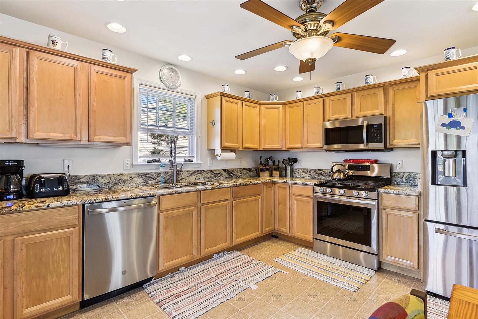 Picture yourself preparing meals in this fully equipped kitchen with granite countertops, stainless steel appliances, and warm wood cabinetry—everything you need to feel right at home during your stay.