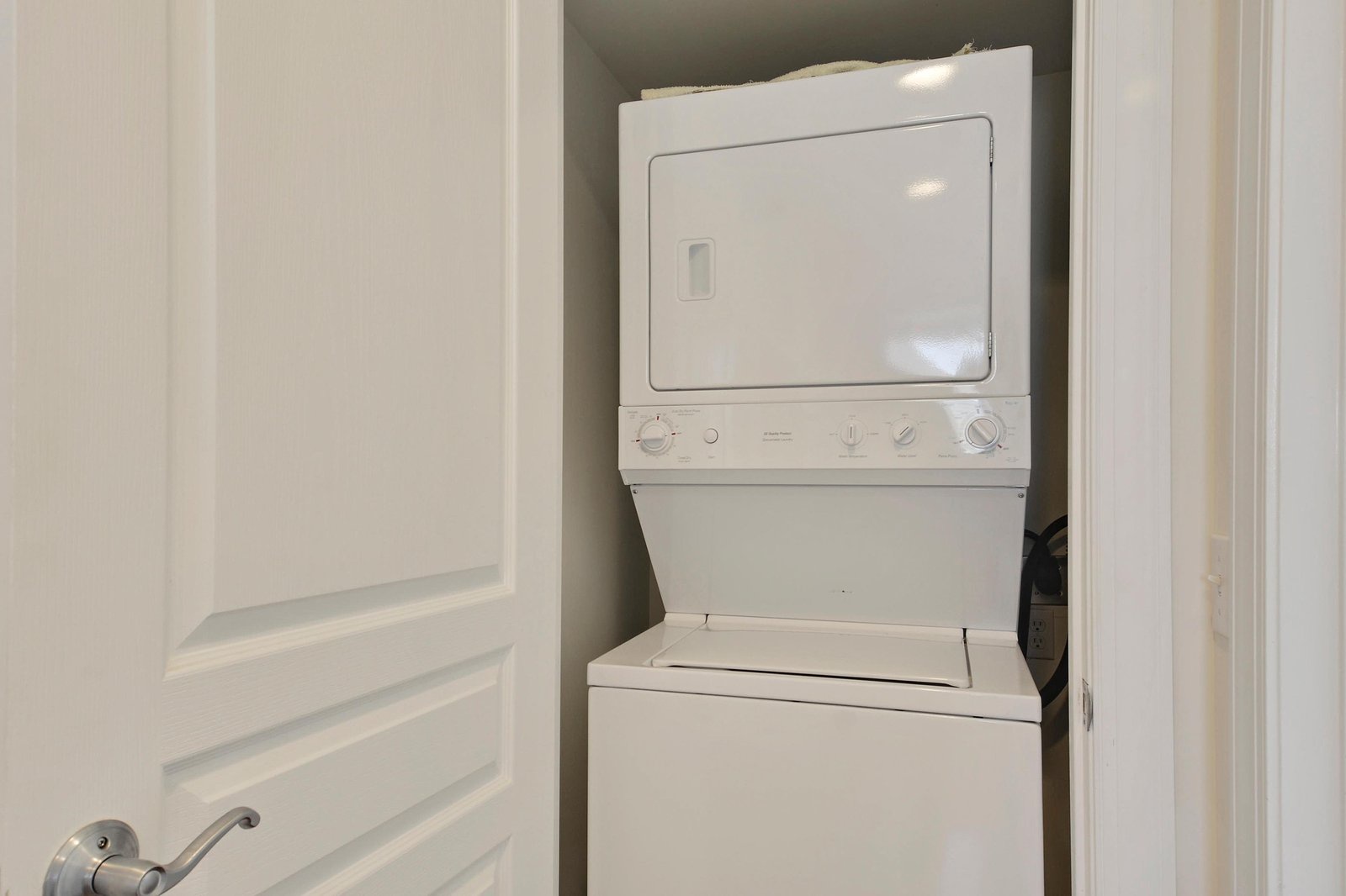A stackable washer and dryer tucked neatly in a closet keep your wardrobe fresh throughout your stay.