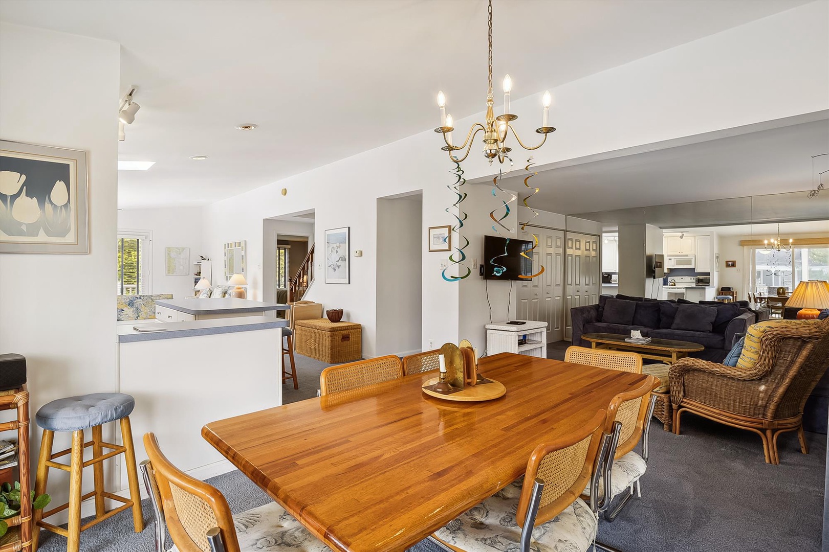 Picture yourself gathered around this welcoming dining table, with the open-plan living room just beyond. Natural light and warm wood tones create a relaxed, inviting space for your stay.