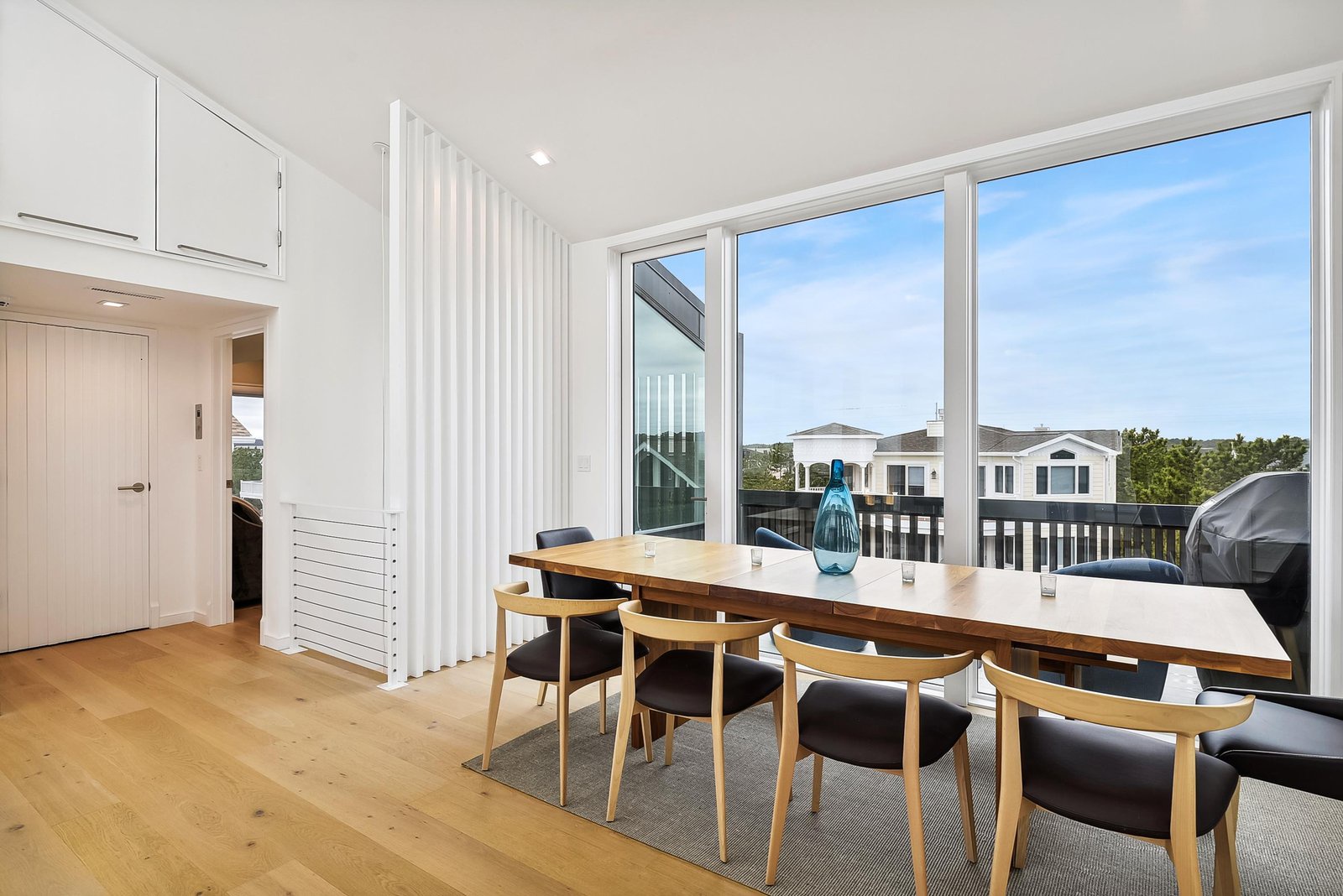 Step inside this bright, modern dining space where floor-to-ceiling windows flood the room with natural light. Your table is set for memorable meals with family and friends, while the balcony beckons you outside to enjoy fresh air and sunshine.