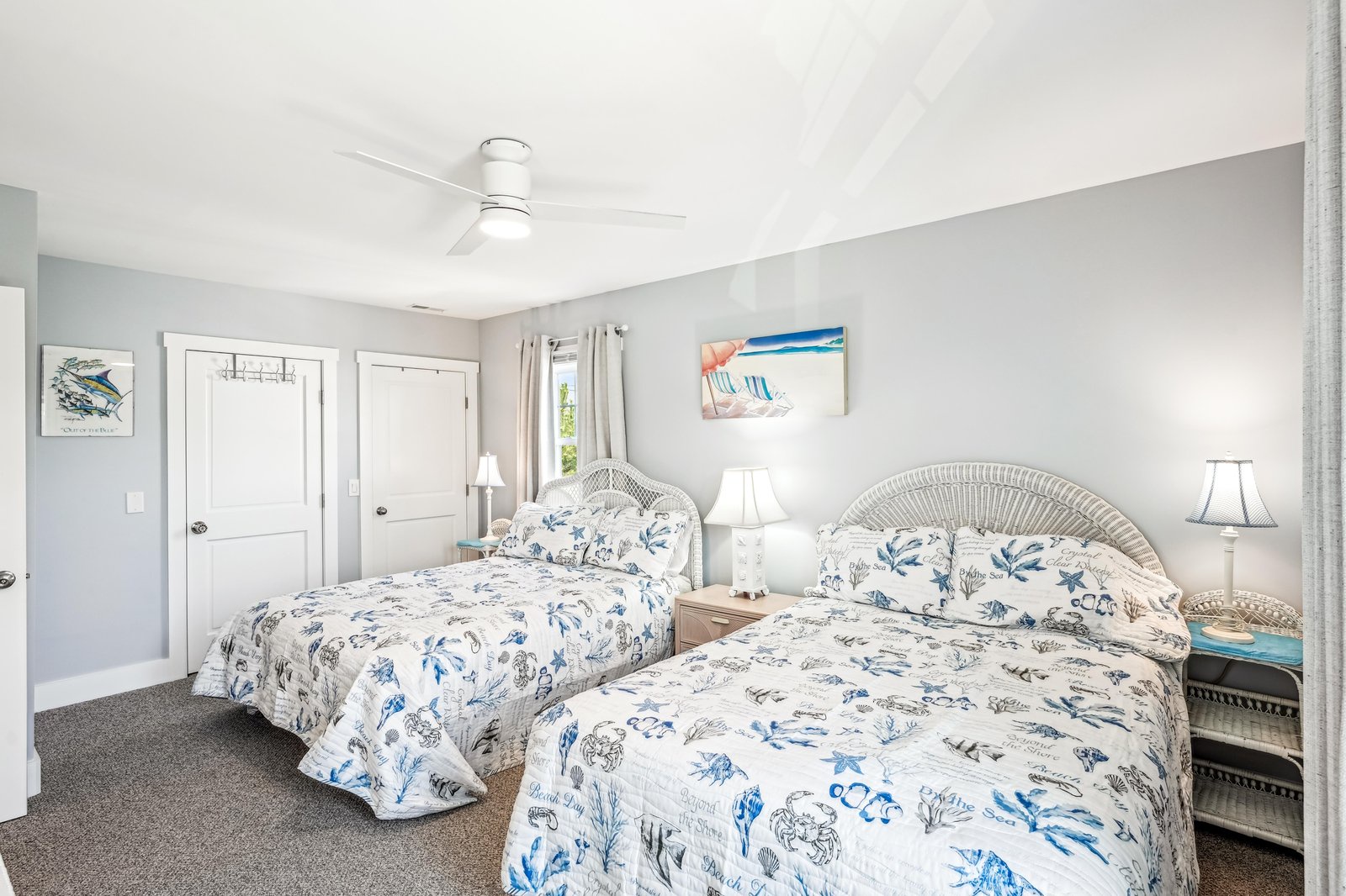 Relax in your serene coastal retreat, where two plush beds invite you to unwind after a day of sun and sand. A gentle ceiling fan and crisp linens promise a restful night's sleep.