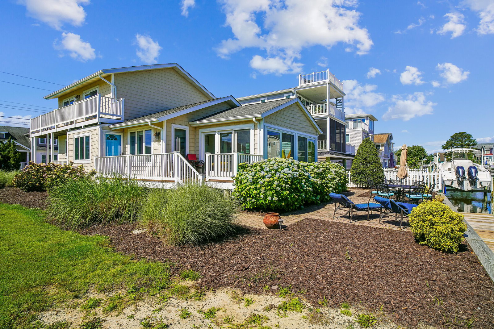 Waterfront vacation home situated on a tranquil canal with private dock access. The property features multiple decks and a landscaped yard, located in a peaceful residential neighborhood.