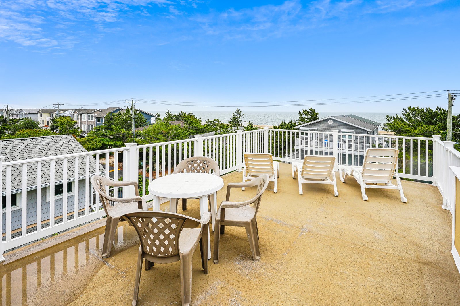 Your private rooftop terrace invites sunny mornings and starlit evenings, complete with lounge chairs for relaxing and a table set for meals outdoors.