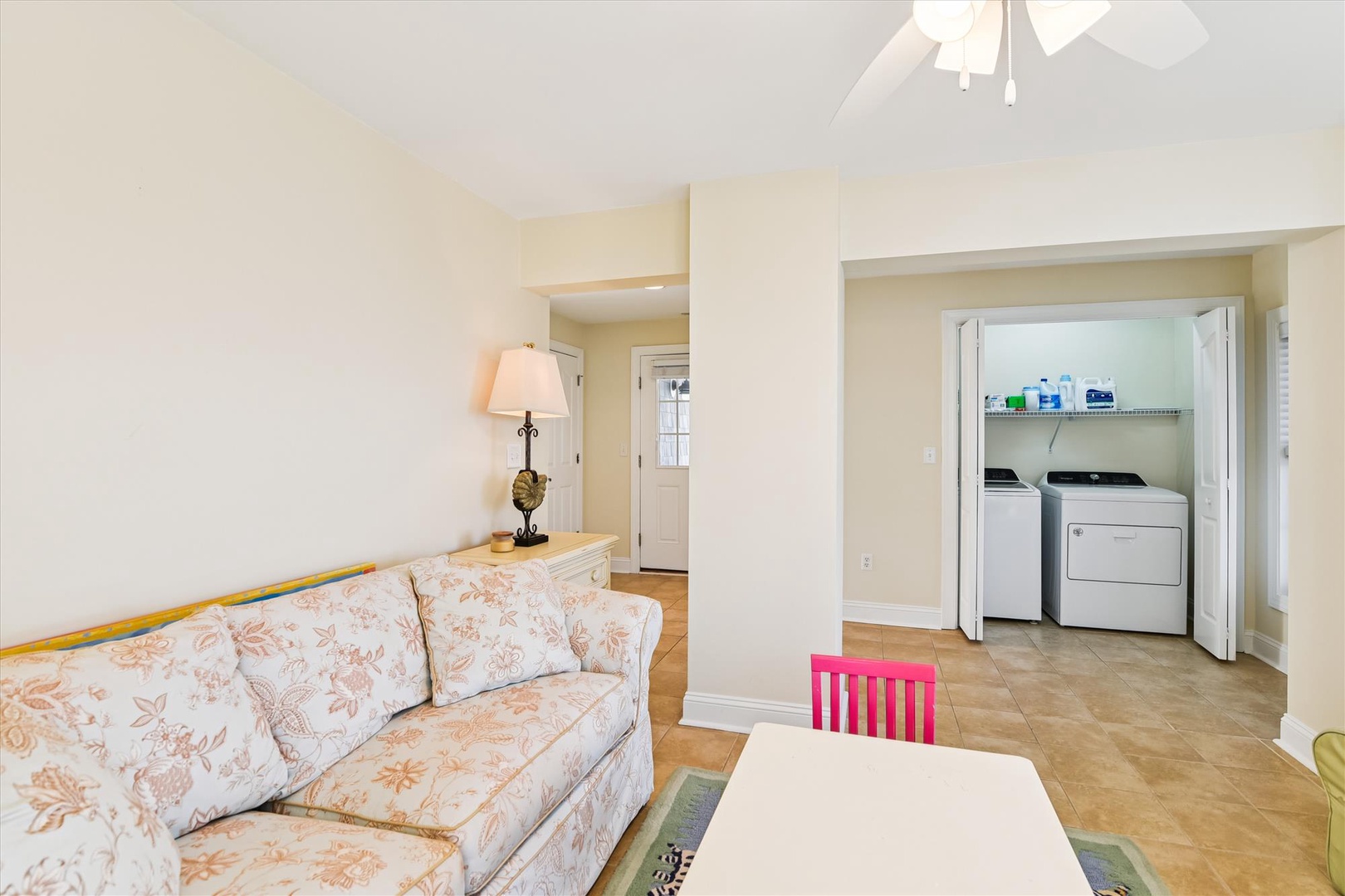 Relax on your comfortable sofa while enjoying the convenience of in-home laundry just steps away—comfort and practicality in one cozy space.