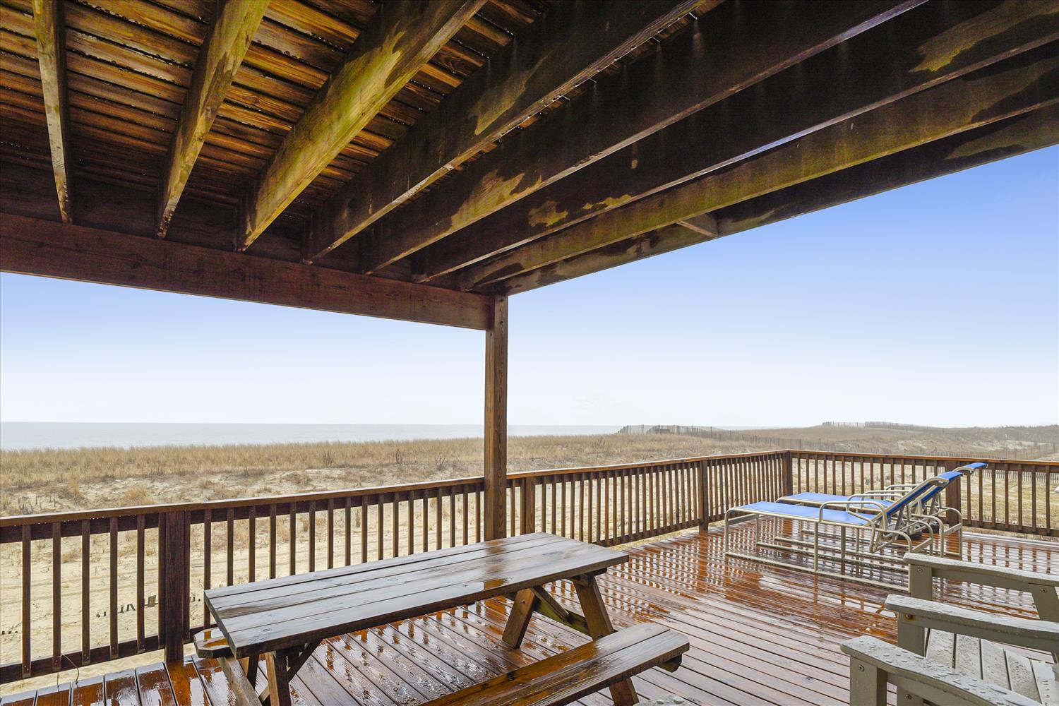 This oceanfront deck offers direct beach access and stunning coastal views. Start your morning with coffee at the picnic table or unwind in the lounge chair as waves roll in just steps away.
