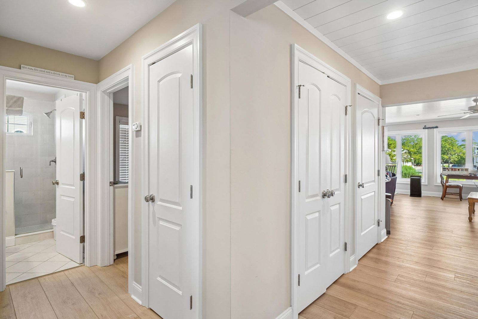 Your home away from home opens up with bright, airy spaces and thoughtfully placed rooms—each door inviting you into comfort, from a sleek bathroom to restful bedrooms, all under charming vaulted ceilings.