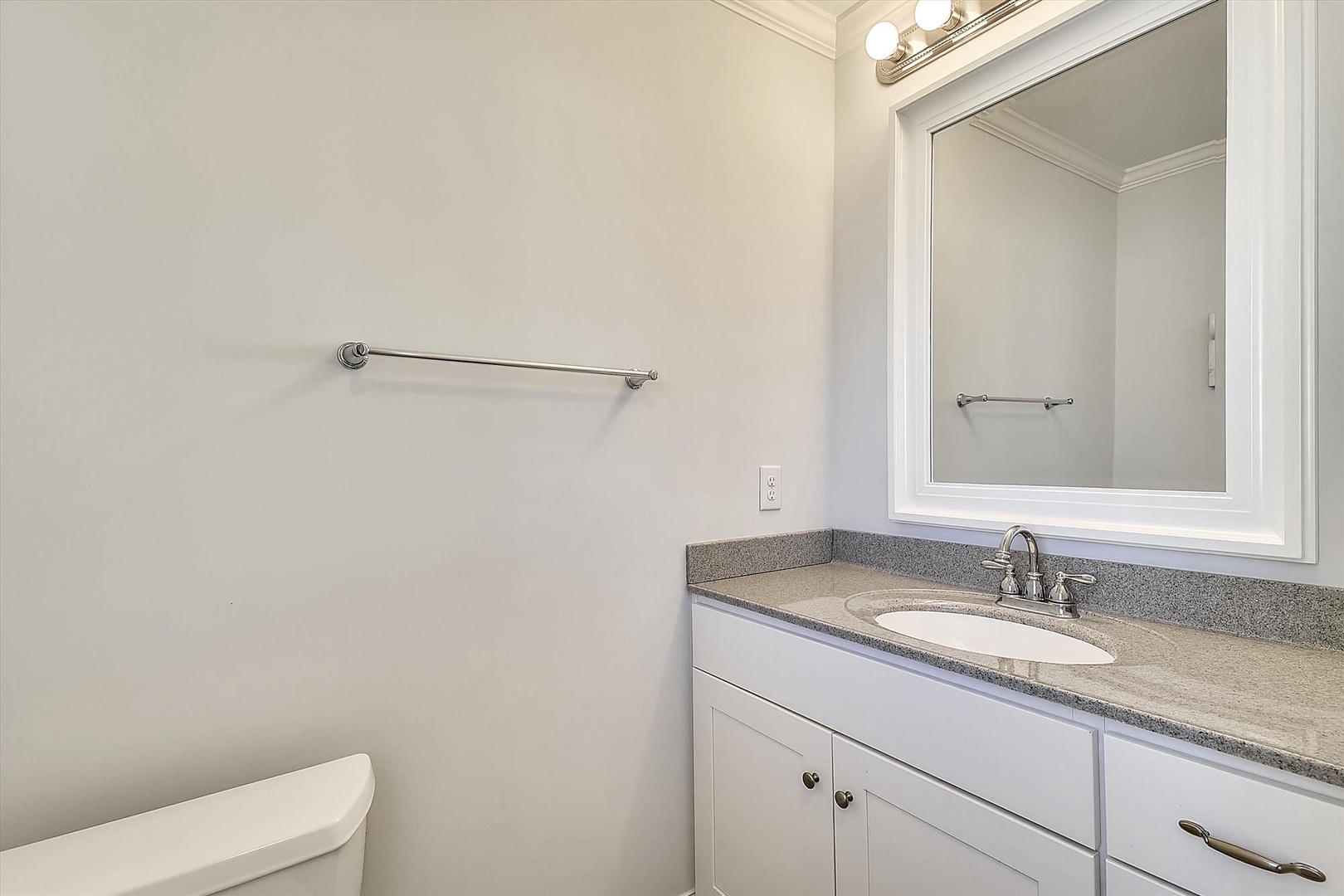 Your private bathroom features clean granite countertops and crisp white cabinetry for a fresh, modern feel.